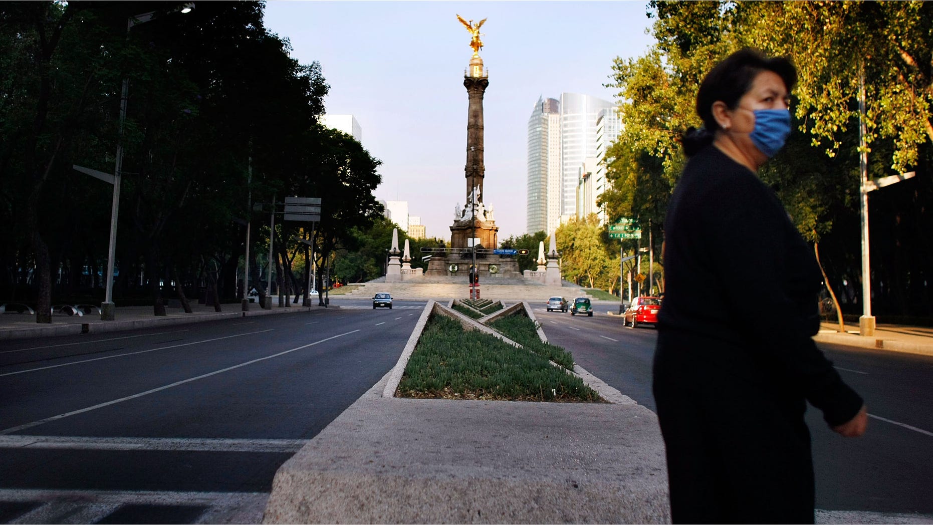 MEXICO CITY - MAY 02: On a normally busy street near the Independence Monument vehicle traffic is light due to the national holiday and the government advising people to stay home in hopes of containing the swine flu on May 2, 2009 in Mexico City, Mexico. The Mexican government continues its efforts to contain the H1N1 virus or the so-called swine flu. Cases have been confirmed in 15 countries, including Mexico and the World Health Organization (WHO) raised the threat level to 'phase 5,' indicating a 'pandemic is imminent. (Photo by Joe Raedle/Getty Images)