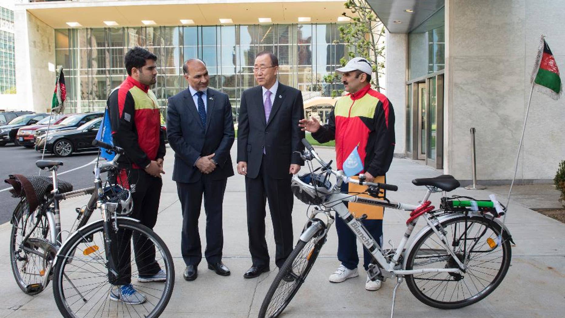 In this photo provided by the United Nations, United Nations Secretary General Ban Ki-moon, center-right, meets with Nader Shah Nangarhari, right, and his son Firoz Khan, left, on the grounds of United Nations headquarters, Friday, May 20, 2016. The father and son team are on a round-the-world trip to promote peace. At center-left is Afghan ambassador to the United Nations, Mahmoud Saikal. (Eskinder Debebe/The United Nations via AP)