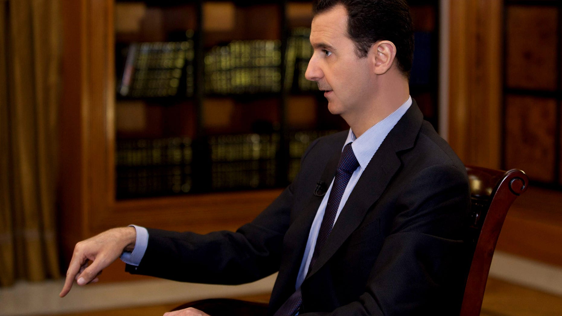 In this photo, which AP obtained from Syrian official news agency SANA and which has been authenticated based on its contents and other AP reporting, President Bashar Assad gestures as he speaks during an interview with Lebanon’s Al-Mayadeen TV, at the presidential palace in Damascus, Syria, Monday, Oct. 21, 2013. Syria’s president said Monday that the factors that would allow a landmark conference aimed at ending the country’s civil war do not yet exist, throwing further doubt on international efforts to hold peace talks that have already been repeatedly delayed. (AP Photo/SANA)