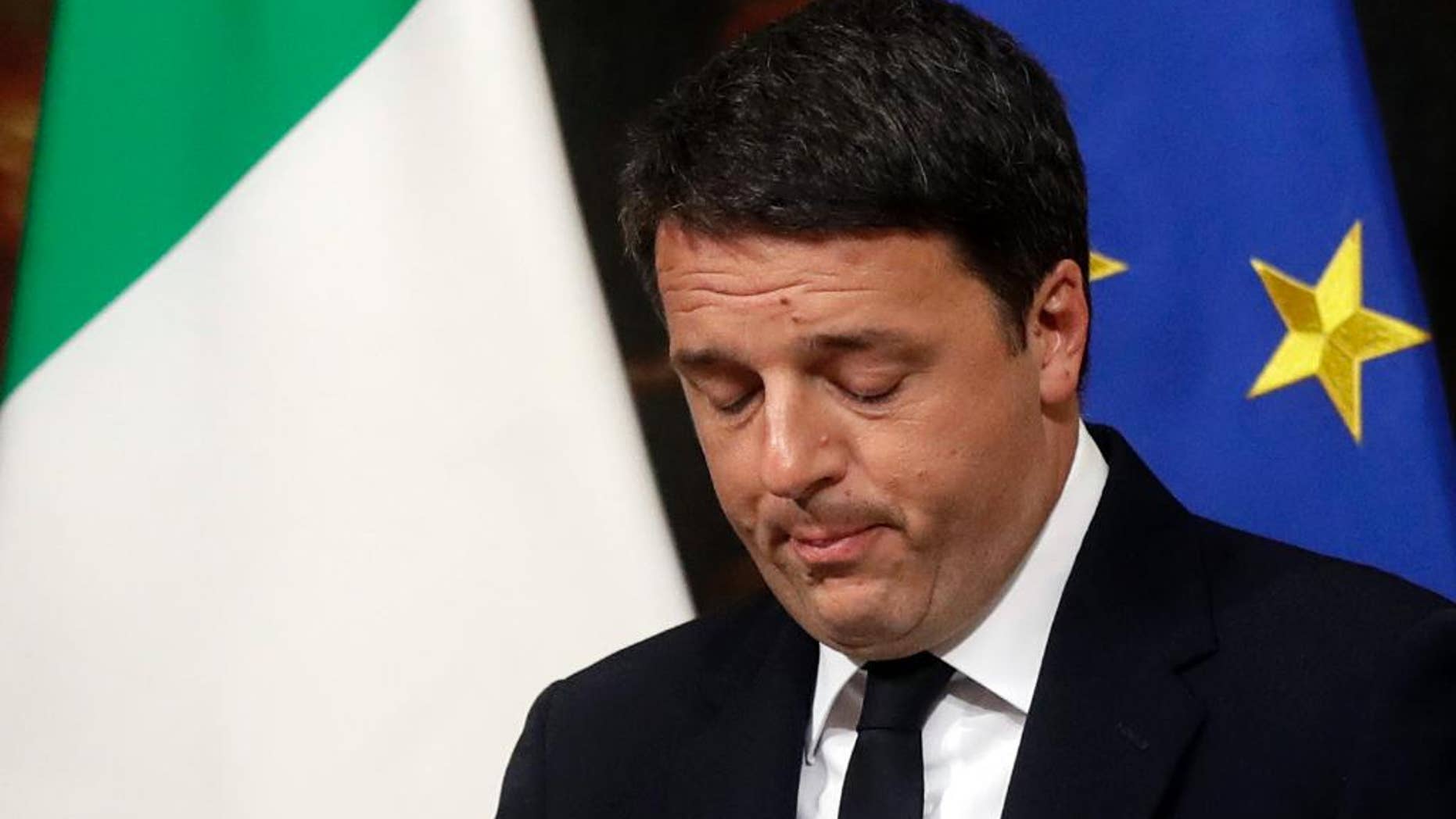 Italian Premier Matteo Renzi speaks during a press conference at the premier's office Chigi Palace in Rome, early Monday, Dec. 5, 2016. Renzi acknowledged defeat in a constitutional referendum and announced he will resign on Monday. Italians voted Sunday in a referendum on constitutional reforms that Premier Matteo Renzi has staked his political future on. (AP Photo/Gregorio Borgia)