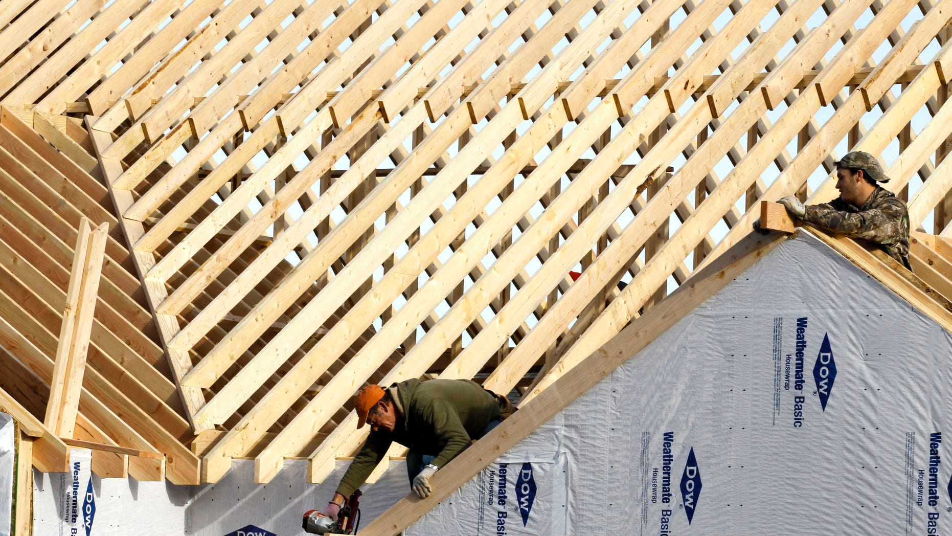 In this Thursday, Dec. 6, 2012, photo a new home is constructed in Pepper Pike, Ohio. US home construction surges 12.1 percent in December to end best year since 2008. (AP Photo/Tony Dejak)