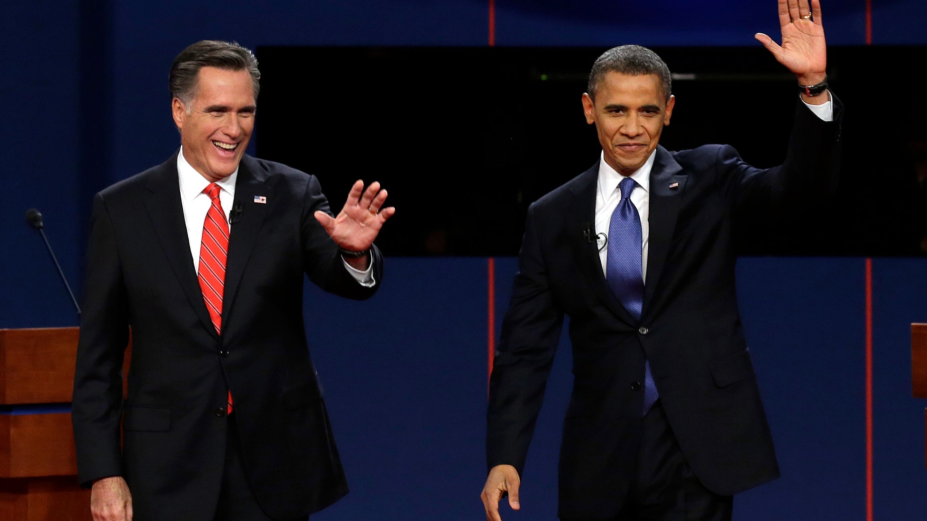 Republican presidential nominee Mitt Romney and President Barack Obama wave to the audience during the first presidential debate at the University of Denver, Wednesday, Oct. 3, 2012, in Denver. (AP Photo/Charlie Neibergall)