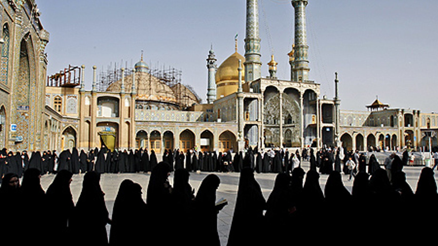 June 12: Iranian women stand in line to cast their votes at Masoumeh shrine in Qum, south of Tehran, Iran.