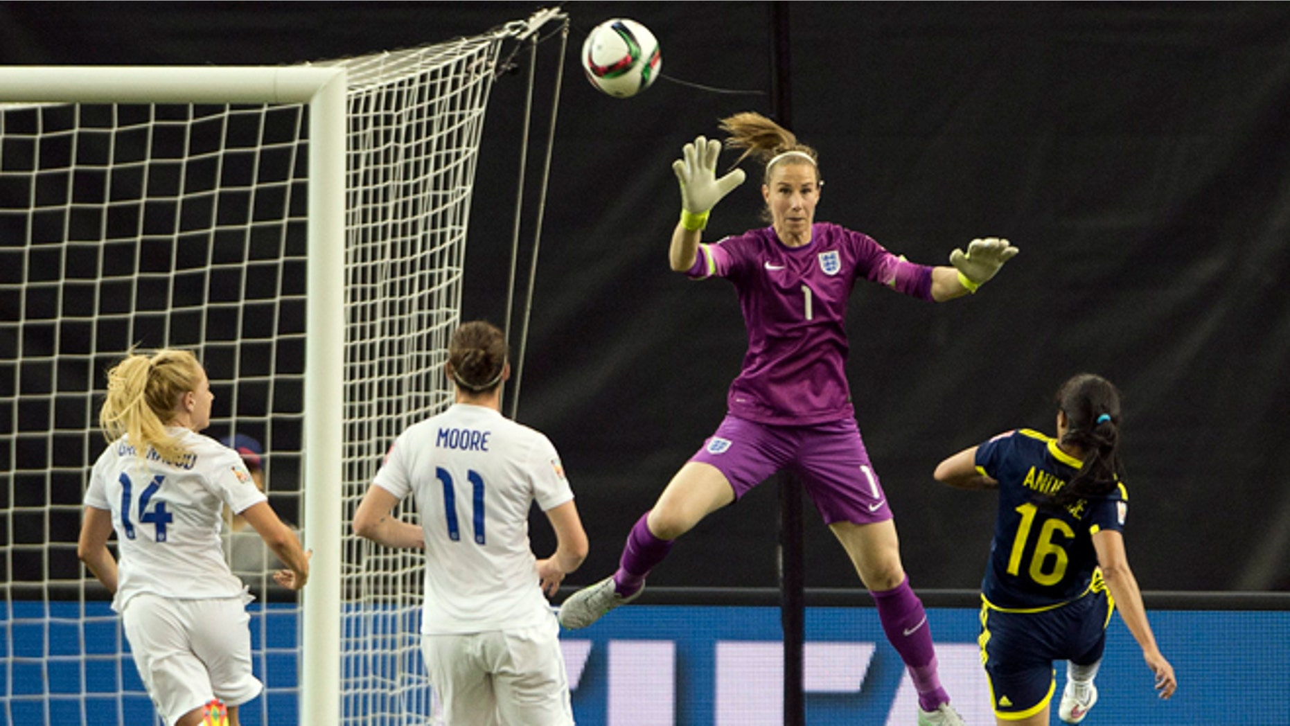 Colombia's Lady Andrade scores on England's goalkeeper Karen Bardsley as England's Alex Greenwood, left, and Jode Moore look on during the second half of a FIFA Women's World Cup soccer match, Wednesday, June 17, 2015, in Montreal, Canada. (Ryan Remiorz/The Canadian Press via AP) MANDATORY CREDIT