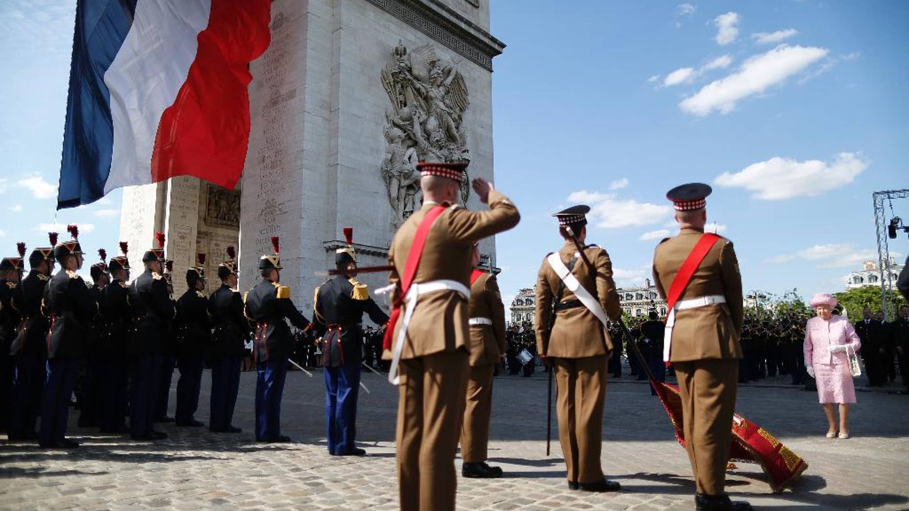 Britain's Queen Elizabeth is accompanied by France's President Francois Hollande as she attends a wreath-laying ceremony at the Arc de Triomphe in Paris, France, Thursday, June 5, 2014. The Queen arrived in Paris to start a three-day state visit and participate in ceremonies commemorating the D-day landings in Normandy. (AP Photo/Charles Platiau,pool)