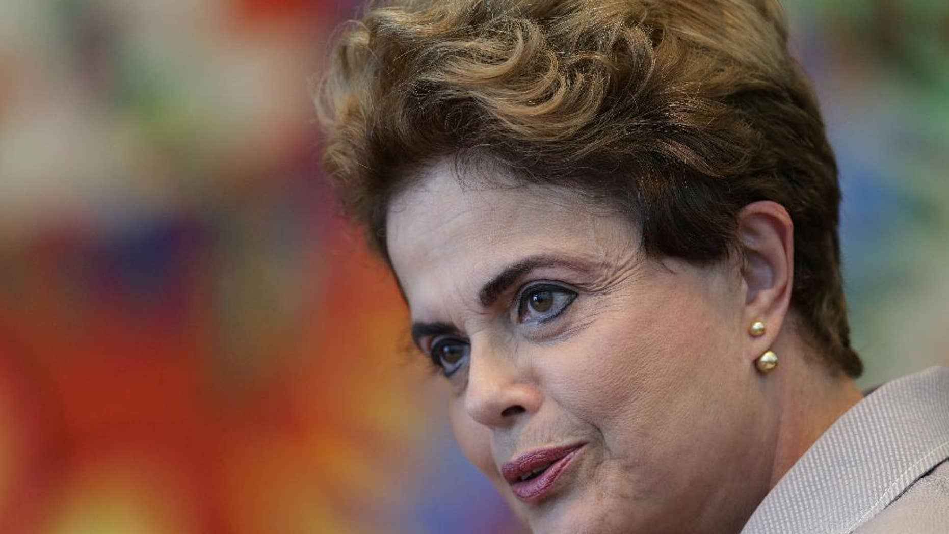 FILE - In this June 14, 2016 file photo, suspended Brazilian President Dilma Rousseff speaks during a press conference for foreign journalists at the Alvorada residential palace, in Brasilia, Brazil. Brazil's Senate voted Wednesday, Aug. 10, 2016, to put Rousseff on trial for allegedly breaking fiscal rules in her managing of the federal budget. (AP Photo/Eraldo Peres, File)