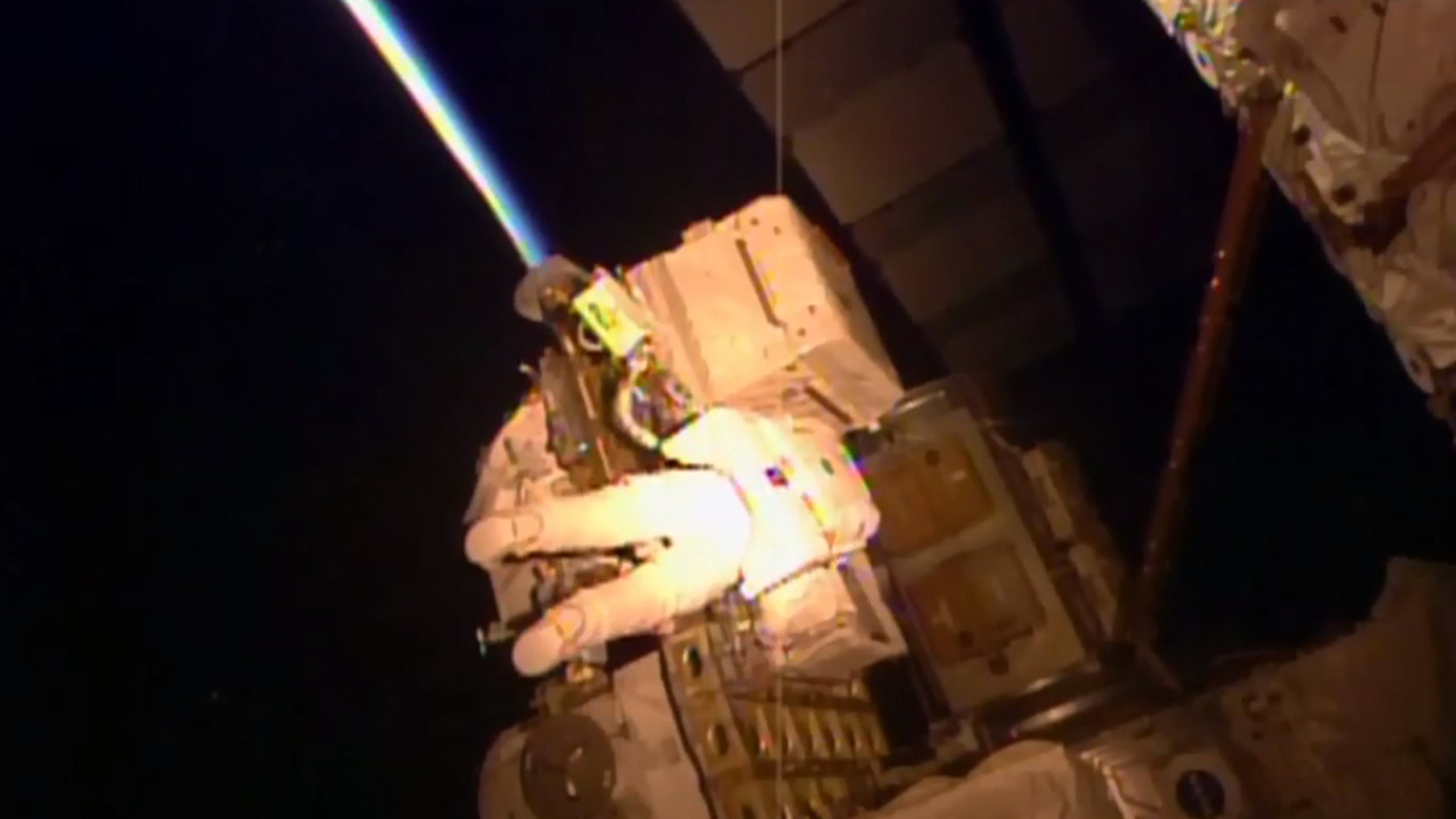 NASA astronaut Kjell Lindgren makes his way towards the Alpha Magnetic Spectrometer on the outside of the International Space Station near the beginning of his spacewalk with mission lead Scott Kelly on Oct. 28. (NASA via AP)