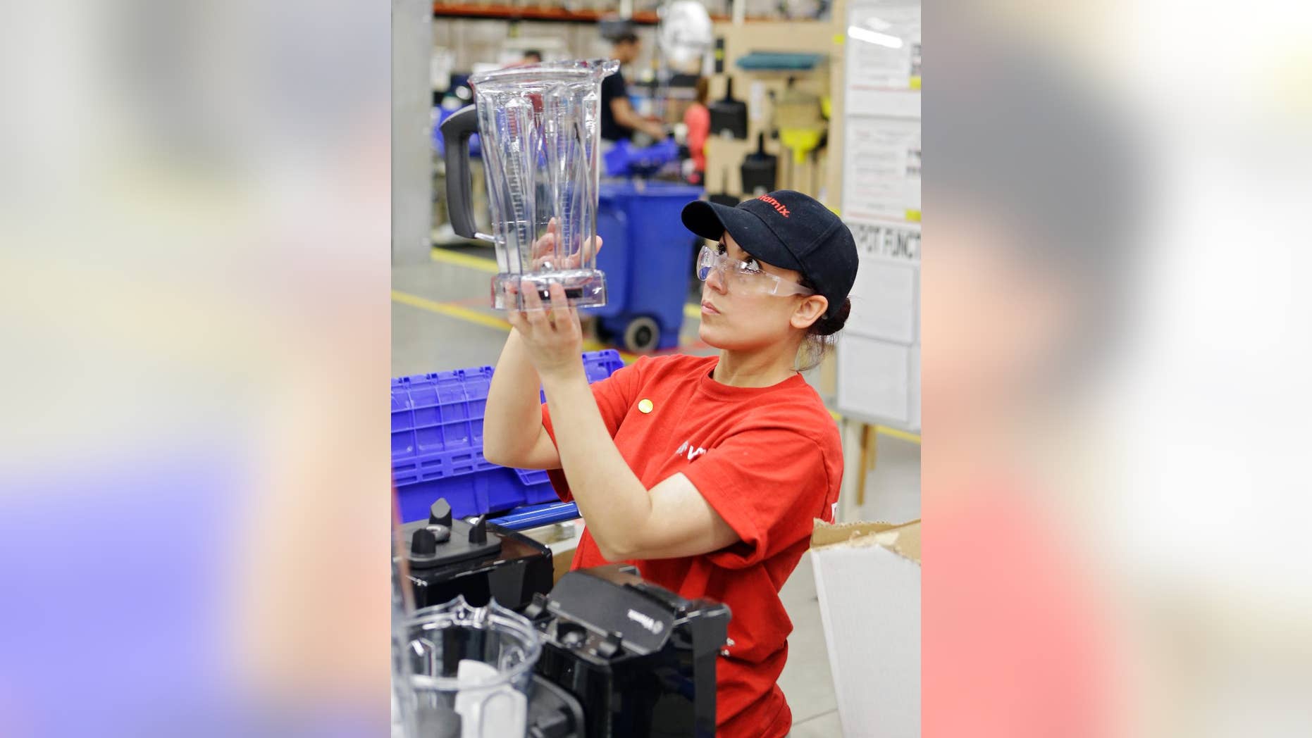 In this Tuesday, April 15, 2014 photo, Glendy Vega inspects a blender container before final packaging at the Vitamix manufacturing facility in Strongsville, Ohio. The Labor Department reports, on Tuesday, Sept. 16, 2014, on U.S. producer price inflation in August. The report measures price changes before they reach consumers. (AP Photo/Mark Duncan)