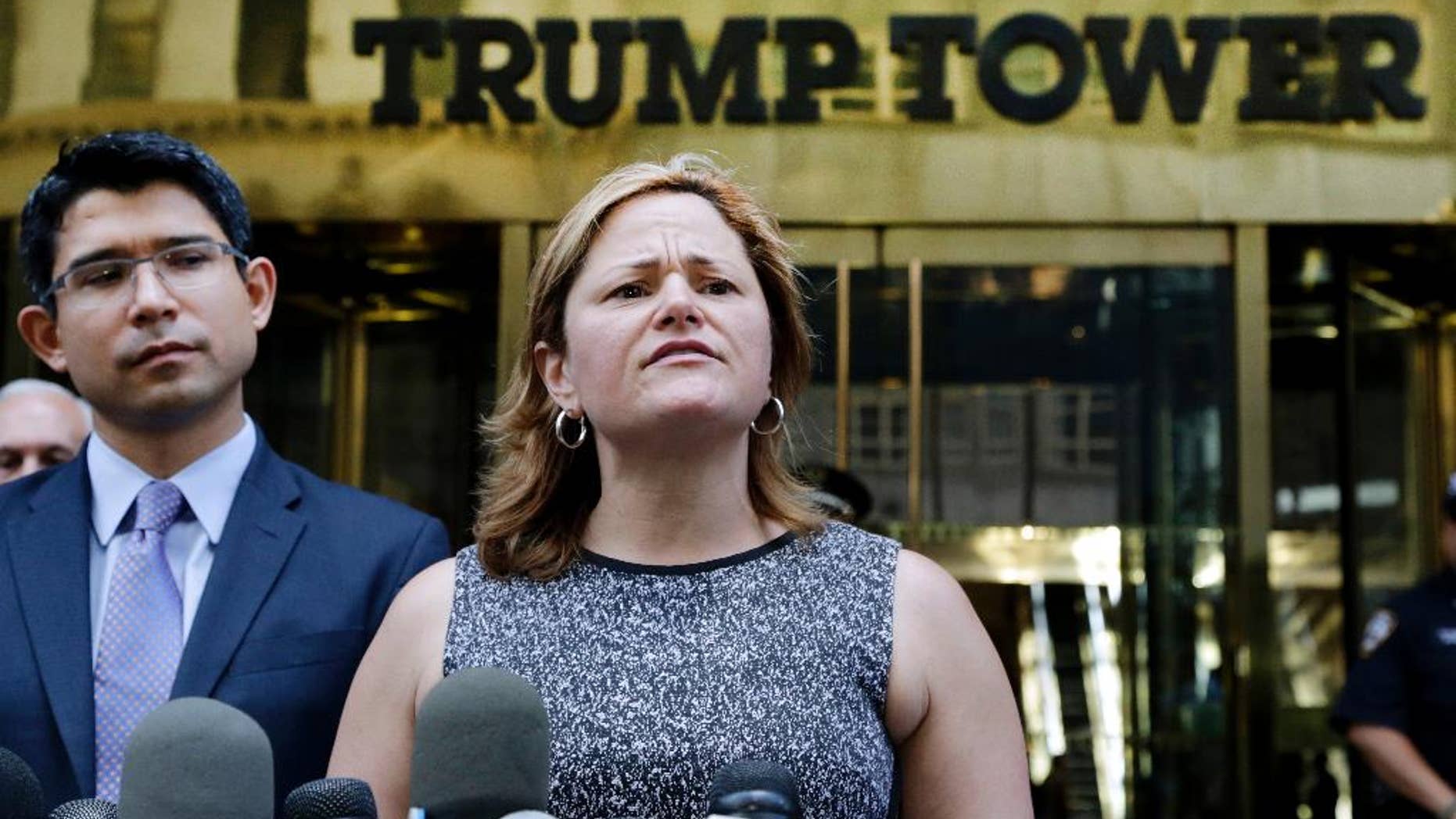 FILE - In this June 6, 2016 file photo, New York City Council Speaker Melissa Mark-Viverito, with City Councilman Carlos Menchaca, left, speaks at a news conference outside Trump Tower in New York. Donald Trump’s lightning-rod proposals to deport illegal immigrants and temporarily ban Muslims from entering the United States could cost New York state more than $800 million and New York City more 340,000 jobs, according to an analysis by Mark-Viverito. She is expected to unveil the findings in a speech Wednesday, July 13, 2016. (AP Photo/Mark Lennihan, file)