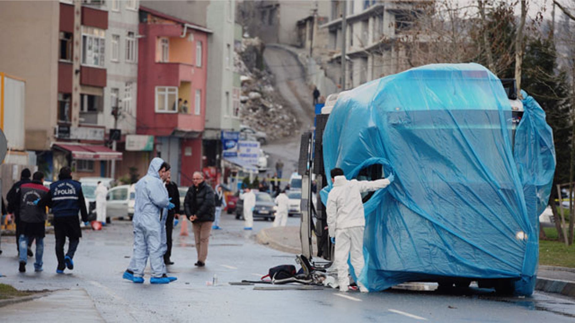 March 1, 2012: Forensic police cover a damaged police vehicle after a bomb went off near the country's ruling party offices in Turkey's largest city, Istanbul.