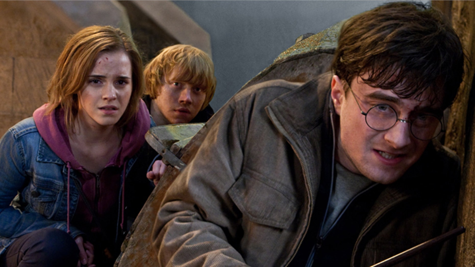 In this film publicity image released by Warner Bros. Pictures, from left, Emma Watson, Rupert Grint and Daniel Radcliffe are shown in a scene from "Harry Potter and the Deathly Hallows: Part 2."