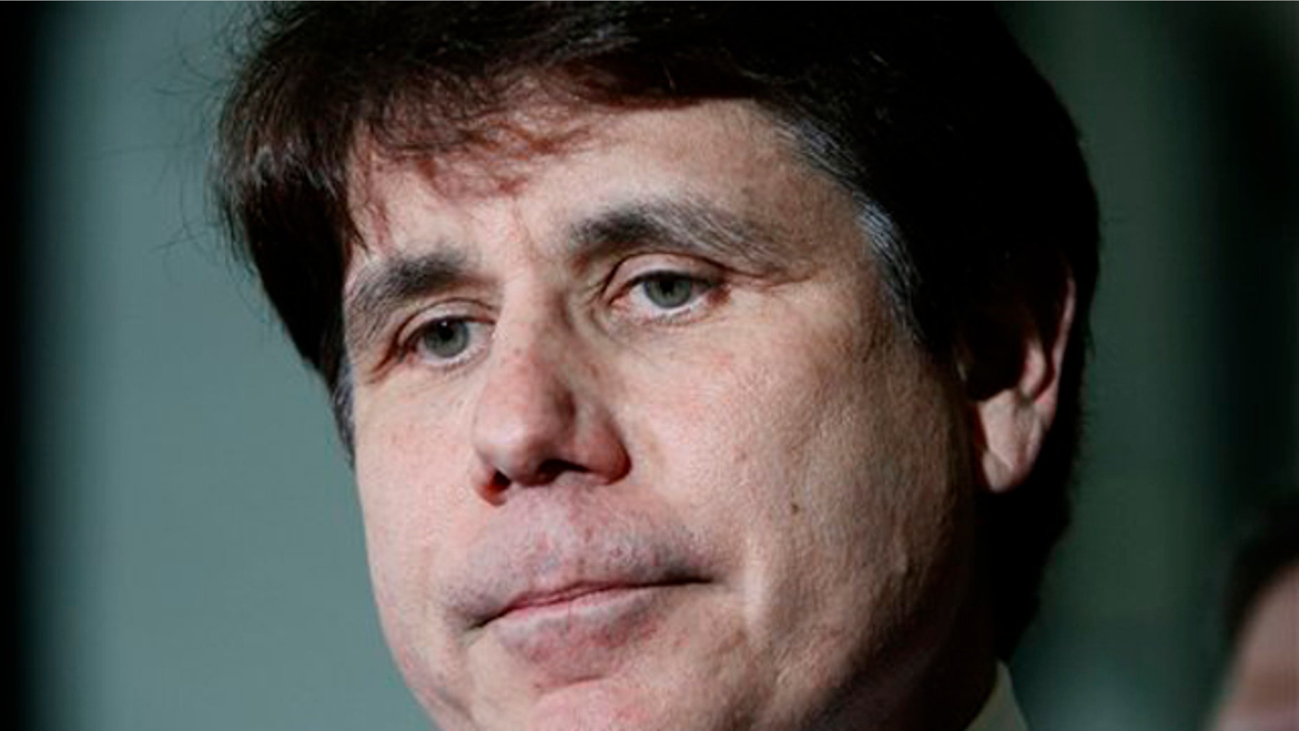 In this June 9 photo, former Illinois Gov. Rod Blagojevich pauses as he talks with reporters at the Federal Court building in Chicago.