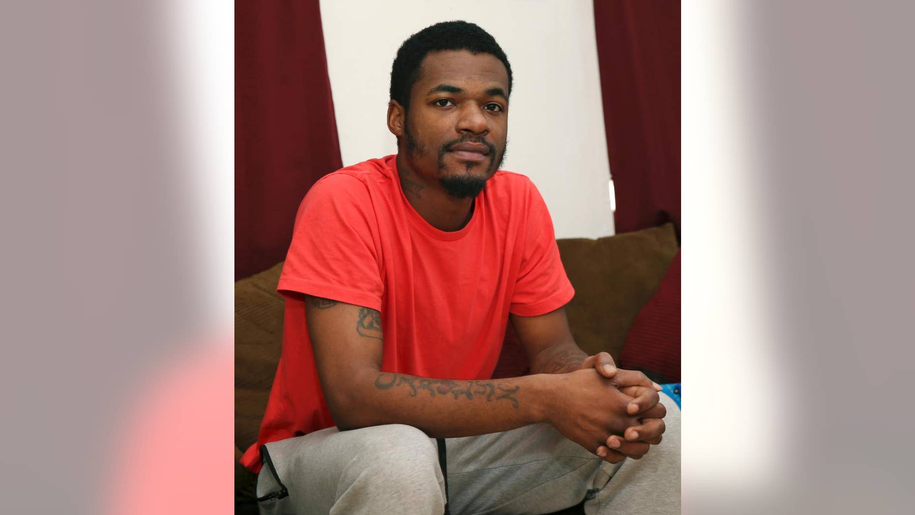 In this Wednesday, Nov. 25, 2015 photograph, Kareem Chappelle sits in his home in Philadelphia. When Chappelle forgot a court date, a bench warrant was issued, and Chappelle turned himself in the day before Thanksgiving. If he’d had $600 for bail, Chappelle could’ve gone home in time for the holiday. Instead, without the money, the first-time offender sat in jail for more than a month, missing Thanksgiving and Christmas with his girlfriend and two young sons. He also lost his home, his car and his job. (AP Photo/Mel Evans)