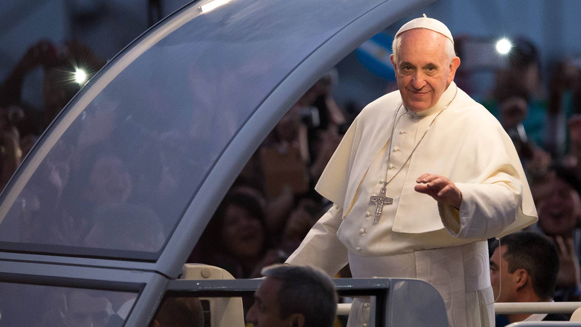 RIO DE JANEIRO, BRAZIL - JULY 26: Pope Francis waves from the Popemobile on his way to attend the Via Crucis on Copacabana Beach during World Youth Day celebrations on July 26, 2013 in Rio de Janeiro, Brazil. More than 1.5 million pilgrims are expected to join the pontiff for his visit to the Catholic Church's World Youth Day celebrations which is running July 23-28. (Photo by Buda Mendes/Getty Images)
