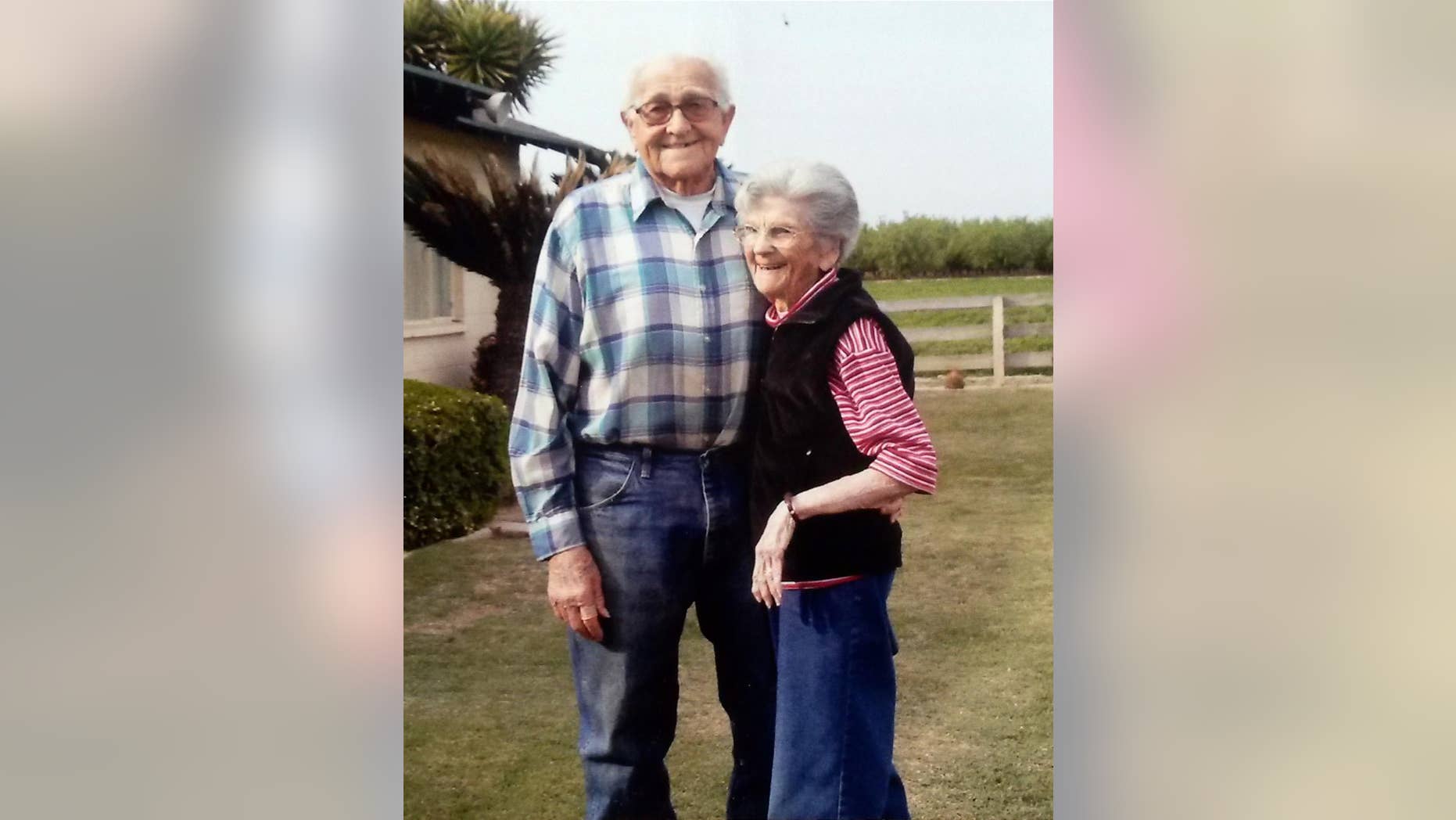 In this March 2014 photo provided by Cynthia Letson, Floyd and Violet Hartwig pose together in a yard in Easton, Calif. The Hartwig's marriage spanned 67 years, but their love for one another appears timeless. Sensing that the couple was close to death, their children pushed their two hospice beds together and gently placed their father's hand in the mother's palm. Floyd, 90, died first. Violet, 89, followed five hours later. They had a good life and died Feb. 11, 2015, at home, just as they had wished, the family said. (AP Photo/Cynthia Letson)