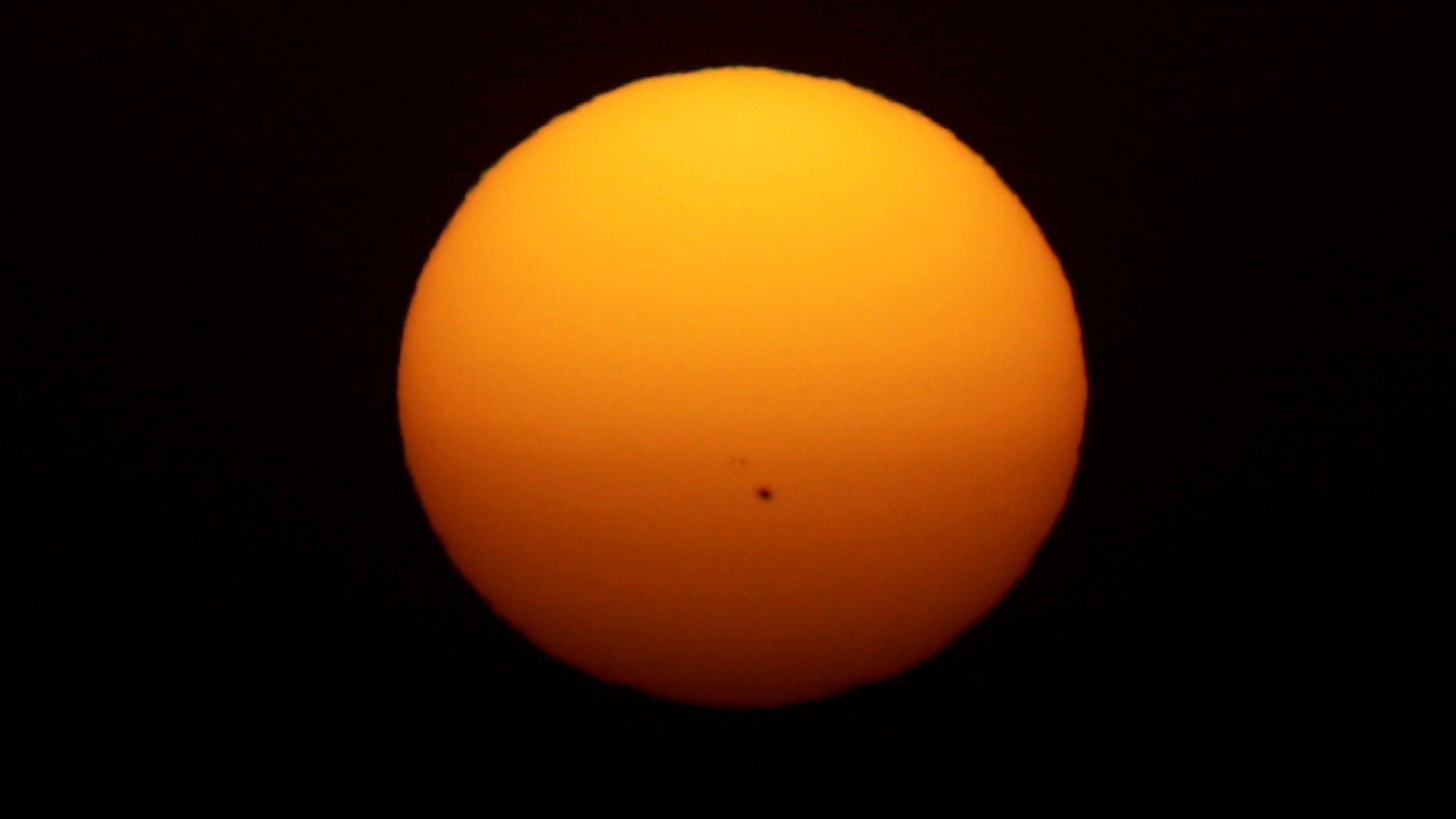 File photo: Sunspots are seen on the sun as it sets during a heatwave in Almargen, Spain, July 12, 2017. (REUTERS/Jon Nazca)