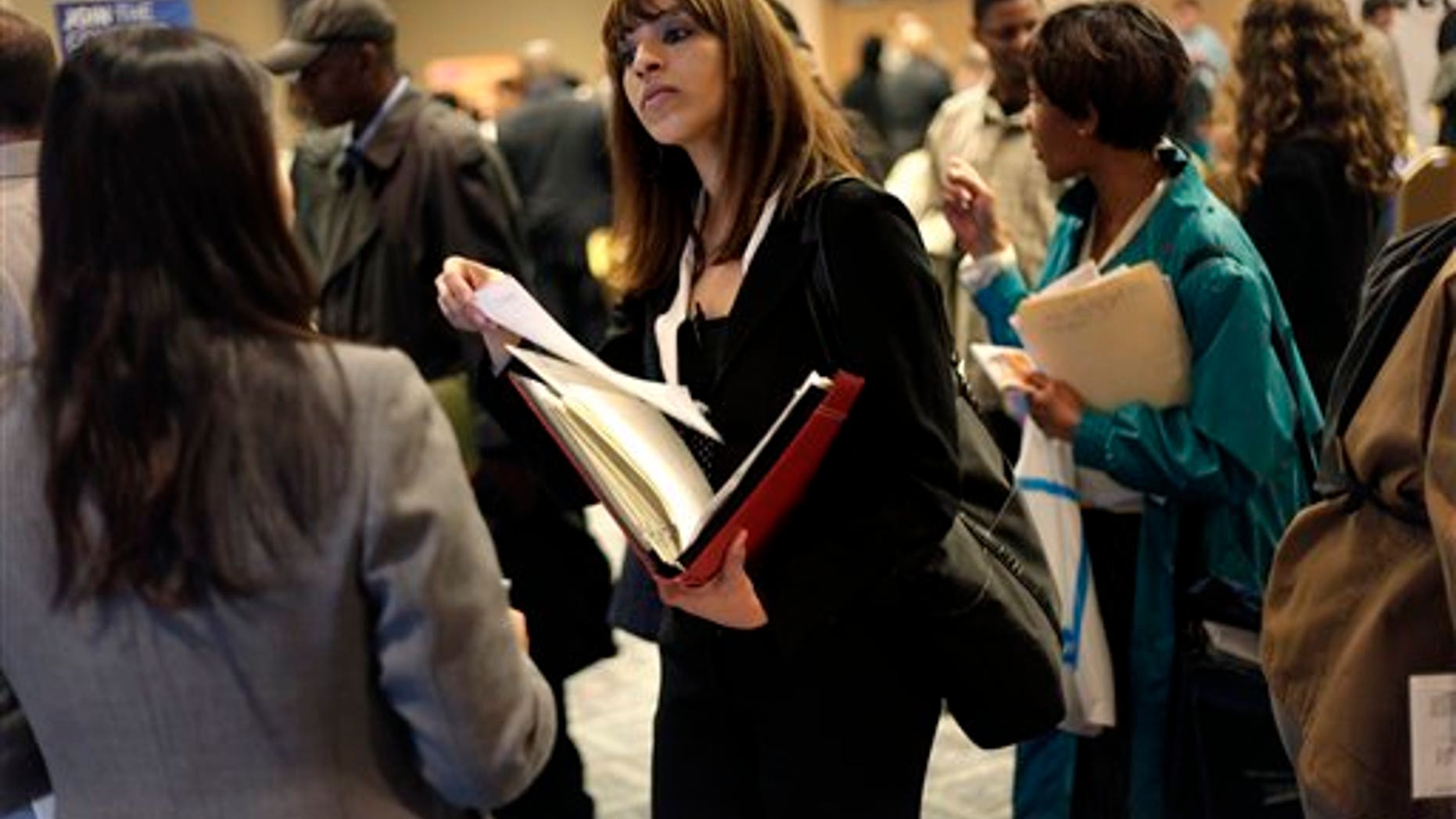 April 18, 2011: A woman at a job fair in New York talks to an employer. (AP Photo/Seth Wenig, File)