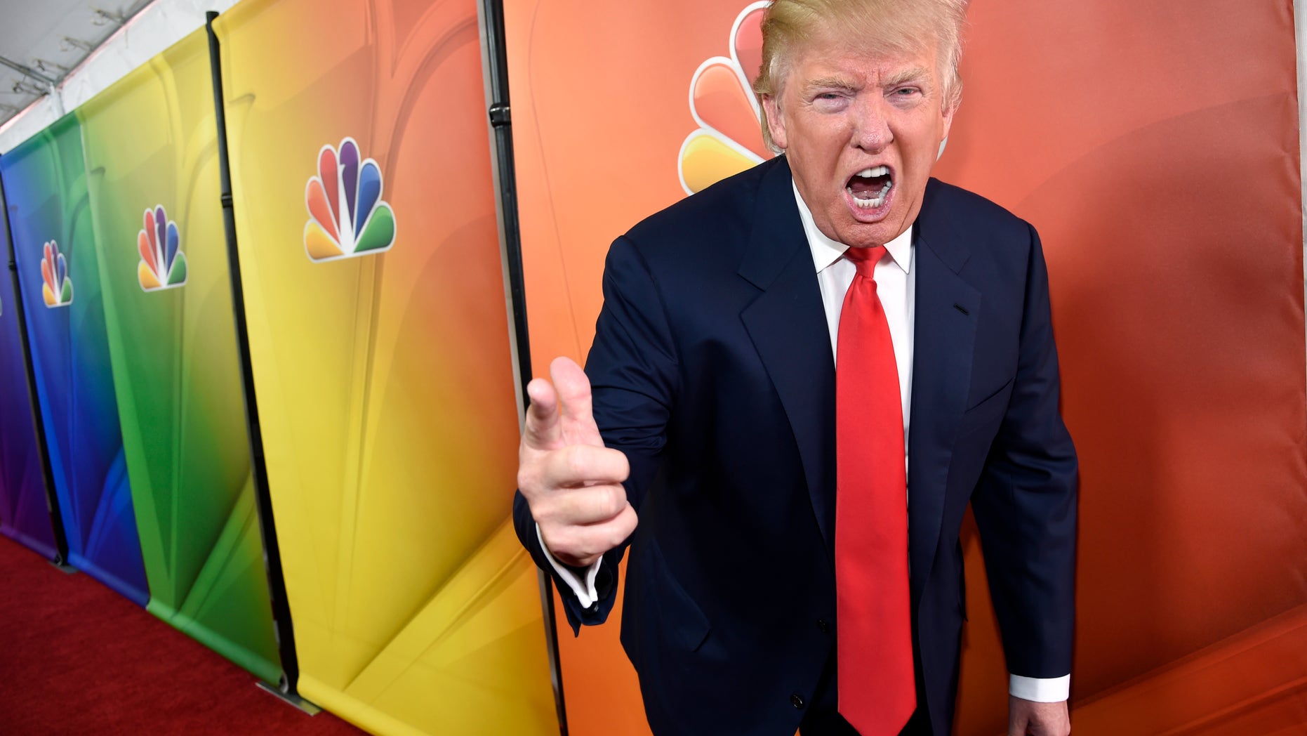 FILE - In this Jan. 16, 2015 file photo, Donald Trump, host of the television series "The Celebrity Apprentice," mugs for photographers at the NBC 2015 Winter TCA Press Tour in Pasadena, Calif. NBC on Monday, June 29, 2015 said that it is ending its business relationship with Trump, now a Republican presidential candidate, because of comments he made about immigrants during the announcement of his campaign. (Photo by Chris Pizzello/Invision/AP, File)