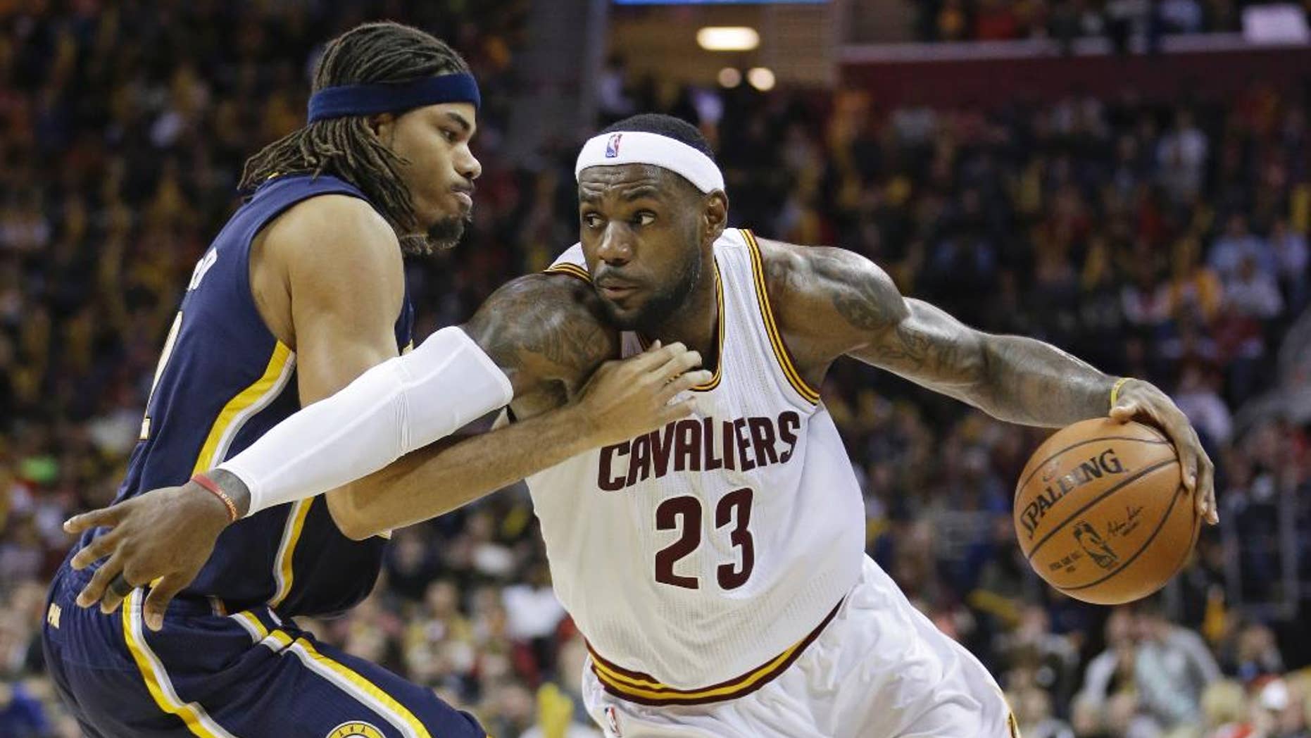 Cleveland Cavaliers' LeBron James, right, drives past Indiana Pacers' Chris Copeland during the third quarter of an NBA basketball game Saturday, Nov. 29, 2014, in Cleveland. The Cavaliers defeated the Pacers 109-97. (AP Photo/Tony Dejak)