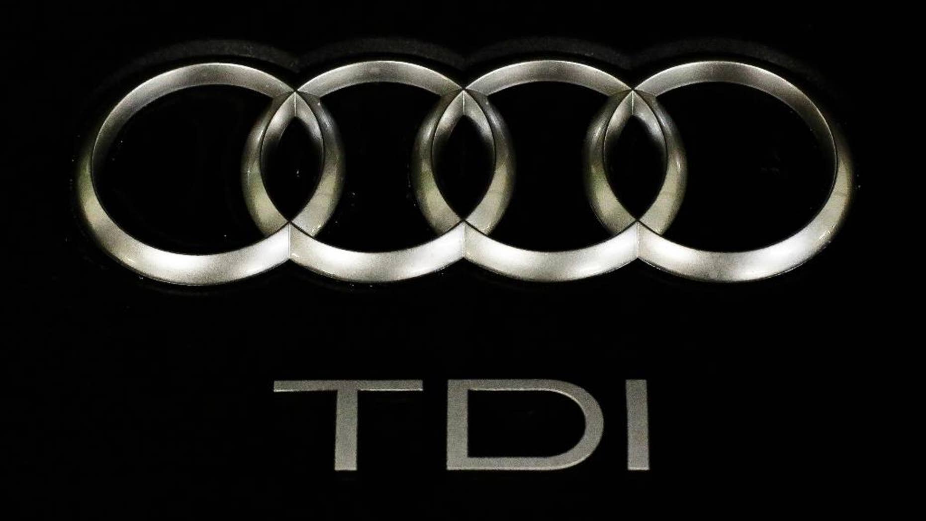 The sign of German car company Audi is attached on the engine of a TDI, a turbo diesel model, in Berlin, Germany, Monday, Sept. 28, 2015. Volkswagen AG's upmarket Audi brand said 2.1 million of its vehicles are among those with the engines affected by the emissions-rigging scandal. (AP Photo/Markus Schreiber)