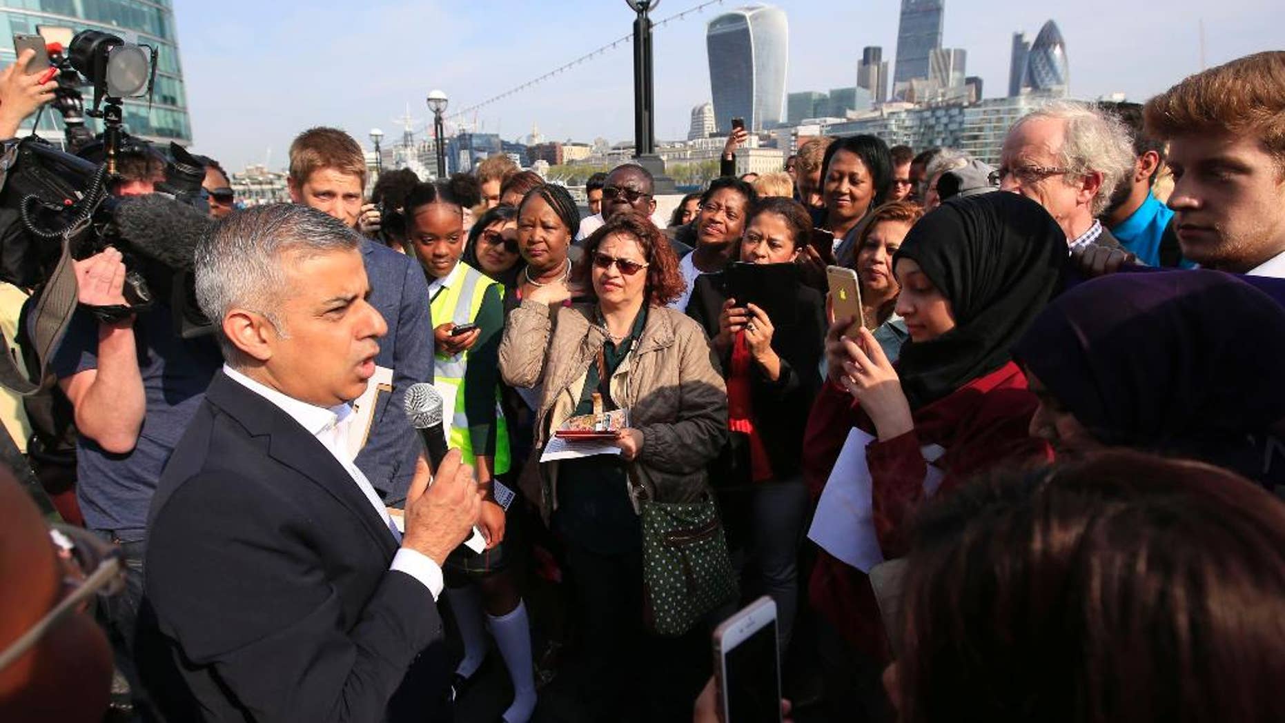 Newly elected London's mayor Sadiq Khan speaks to the media and well wishers outside City Hall in London, on his first day as mayor, Monday May 9, 2016. (Jonathan Brady/PA via AP) UNITED KINGDOM OUT