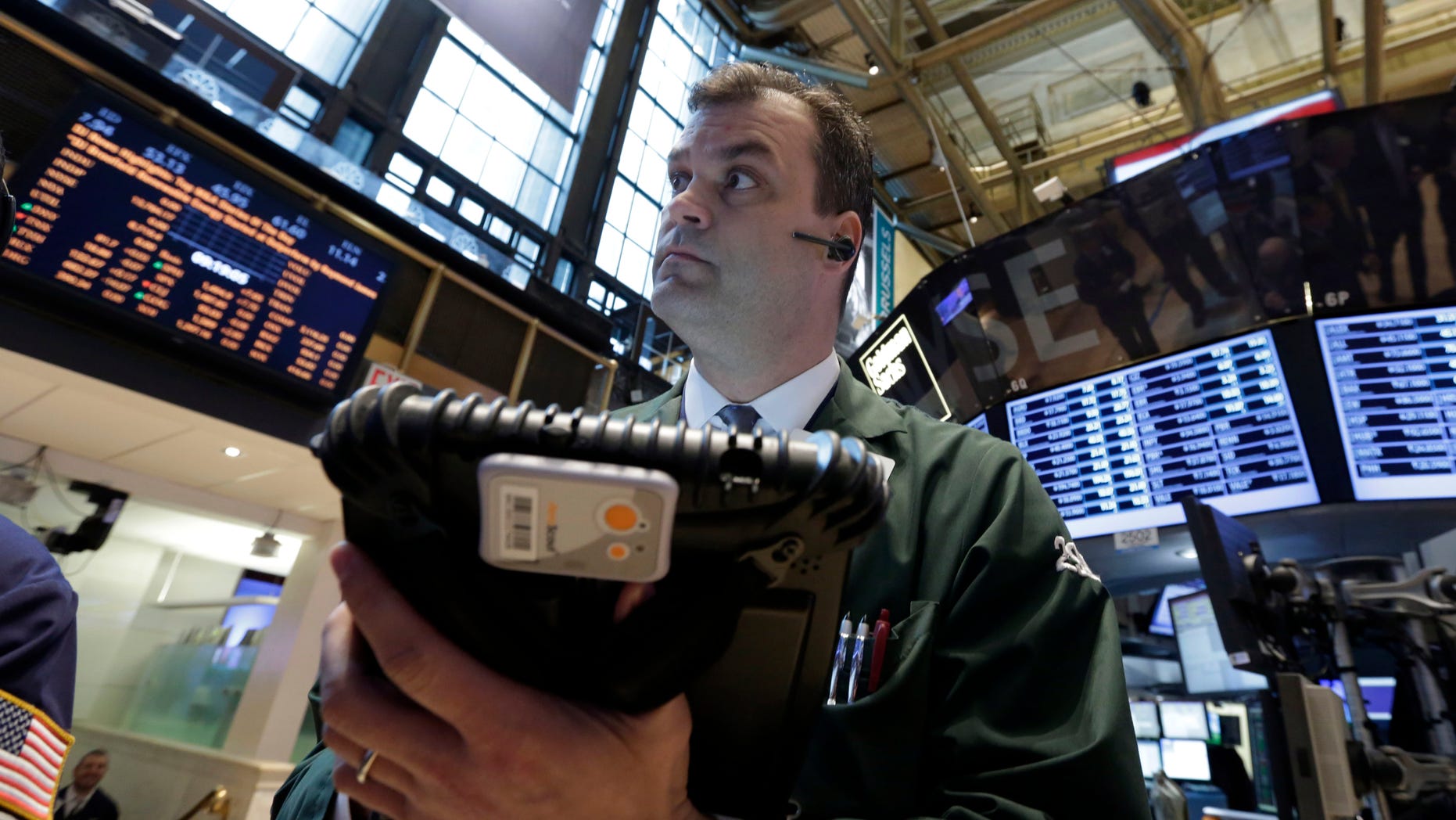 In this Tuesday, Feb. 26, 2013, photo, Trader William Lawrence works on the floor of the New York Stock Exchange.Futures are rising as Chairman Ben Bernanke heads to Capitol Hill to explain what the Federal Reserve will do to accelerate the economic recovery. (AP Photo/Richard Drew)