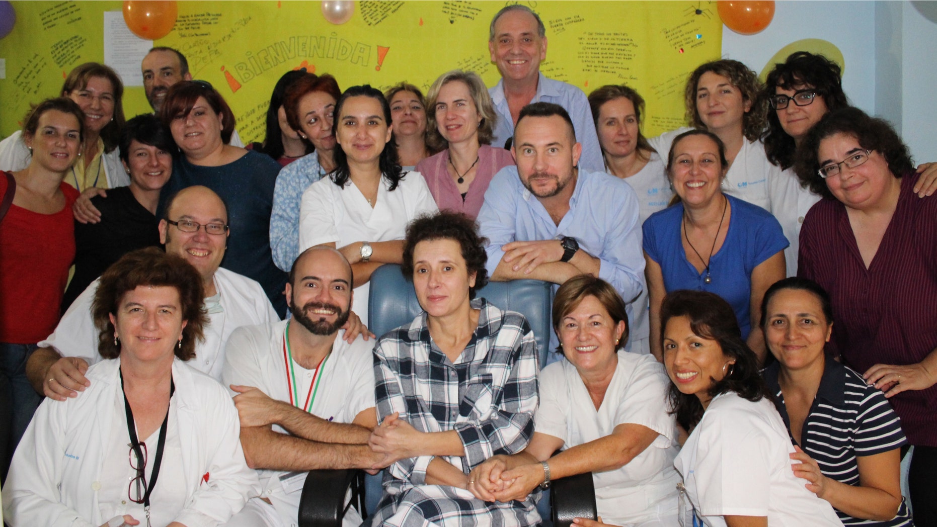 This Nov. 1, 2014 photo provided by the Madridâs Carlos III hospital shows Teresa Romero, center, posing for a photo with medical workers and friends after leaving the isolation unit in the Carlos III hospital in Madrid, Spain. Hospital officials say a Spanish nursing assistant who recovered from an Ebola virus infection has left the isolation unit where she was being monitored and moved to a normal room. Teresa Romero tested positive on Oct 6, but was declared cured of the virus 15 days later. She was the first known person to contract the disease outside of West Africa in the latest outbreak. Madridâs Carlos III hospital said Saturday that Romero, 44, was now being attended by hospital staff that no longer needed to wear protective outfits. (AP Photo)