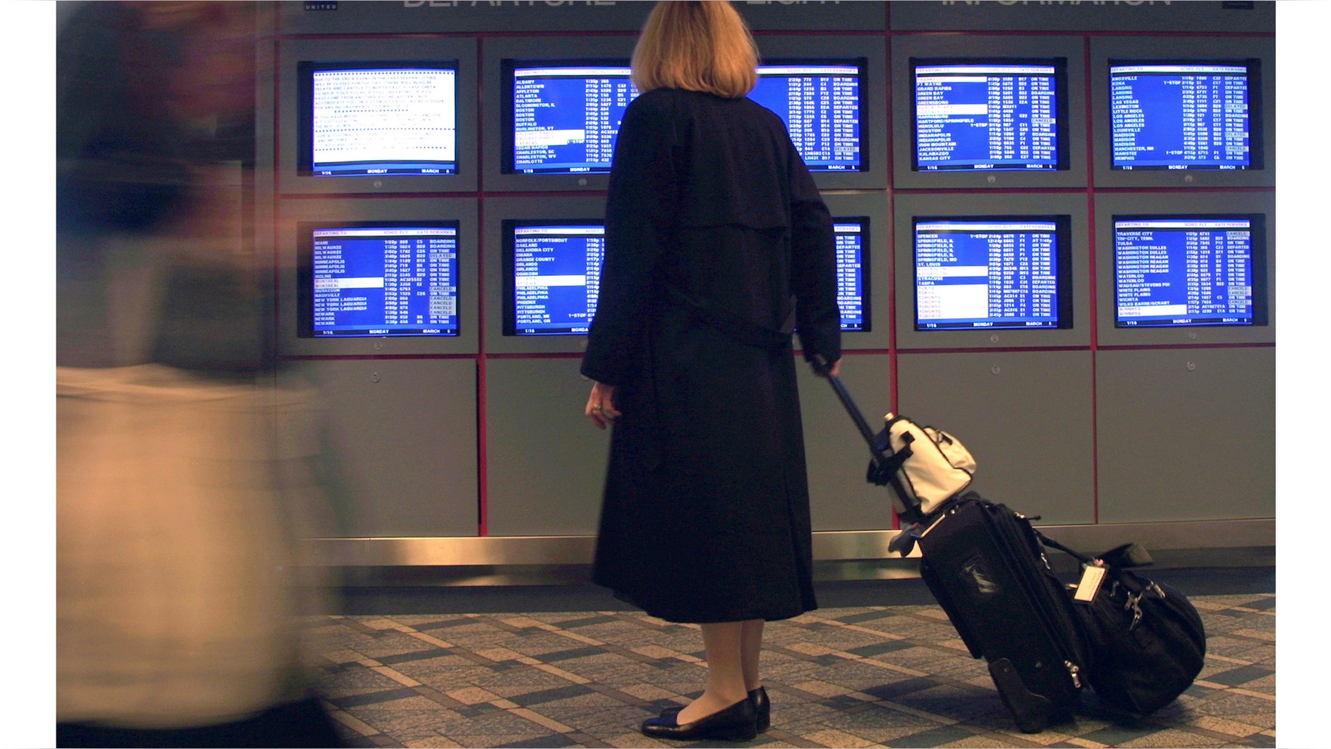 386325 02: A United Airlines flight attendant stops to look at a departure flight information display March 5, 2001 at O''Hare International Airport in Chicago, IL. Hundreds of airline flights in and out of the Northeast United States were canceled as a "Nor''easter" winter storm threatened to blast the region with snow and ice. (Photo by Tim Boyle/Newsmakers)