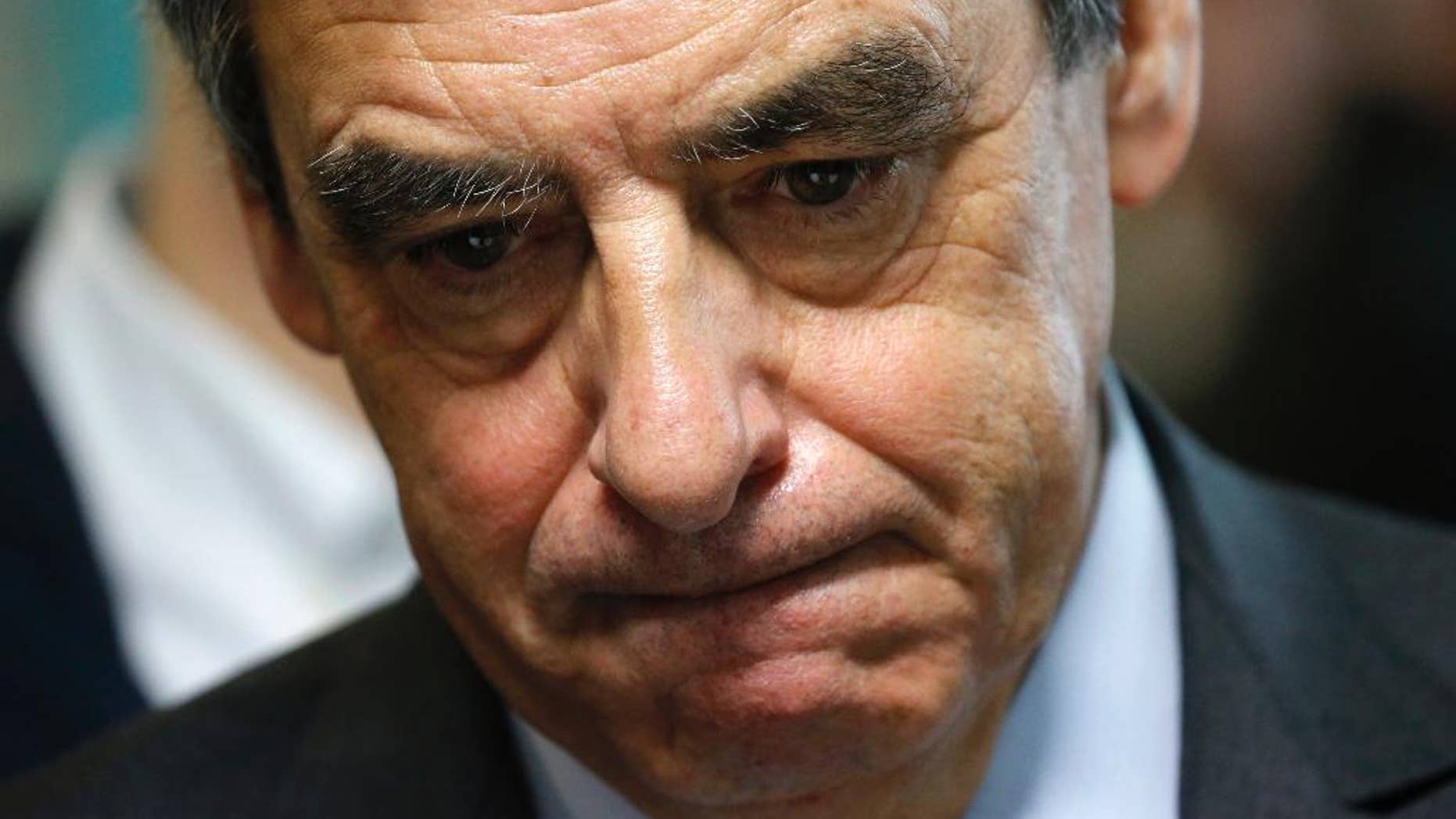 French conservative presidential candidate Francois Fillon reacts as he visits a social center as he campaigns in Tourcoing, northern France, Friday Feb. 17, 2017. French financial prosecutors decided Thursday to continue their investigation of embezzlement allegations against conservative presidential candidate Francois Fillon, saying they have too much evidence to drop the case. (Pascal Rossignol, Pool via AP)