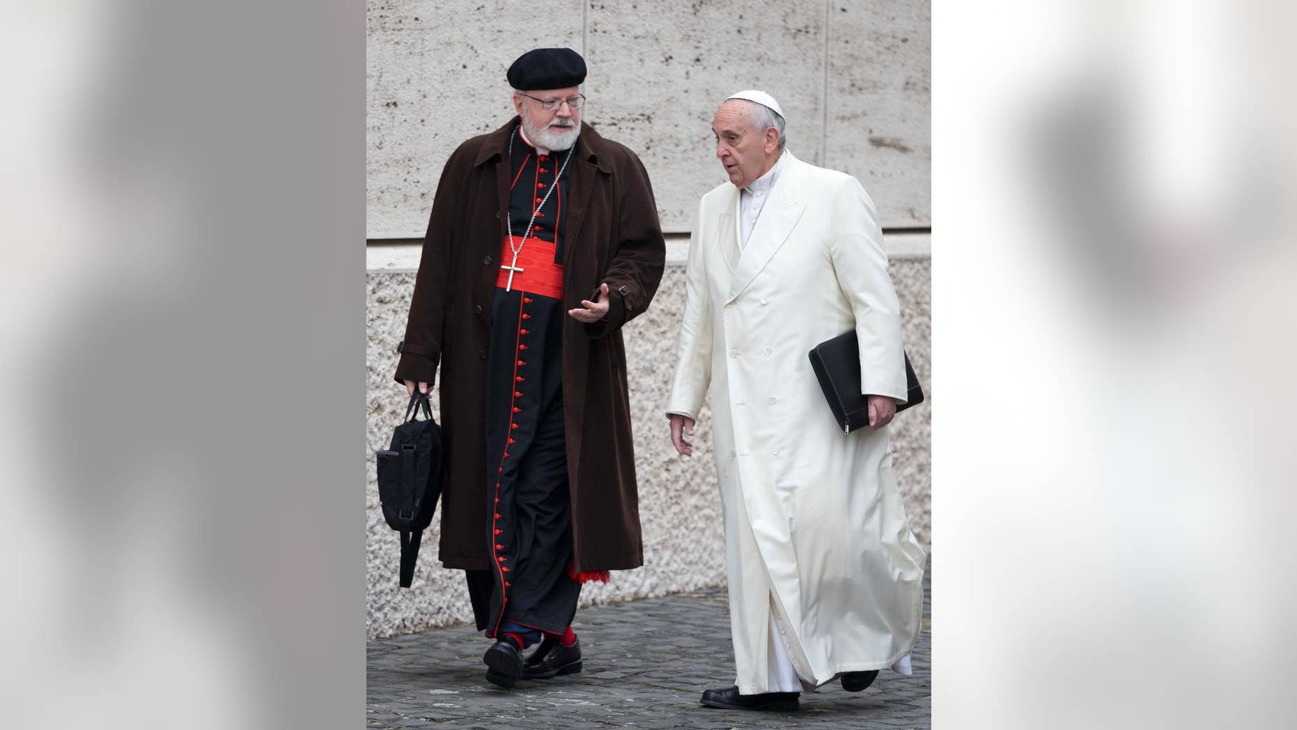 FILE - In this Feb. 13, 2015 file photo, Pope Francis, right, talks with the head of a sex abuse advisory commission, Cardinal Sean Patrick O'Malley, of Boston, as they arrive for a special consistory in the Synod hall at the Vatican. Pope Francis has quietly reduced sanctions against a few pedophile priests, applying his vision of a merciful church even to its worst offenders in ways that abuse survivors and the pope's own advisers question. (AP Photo/Andrew Medichini, File)