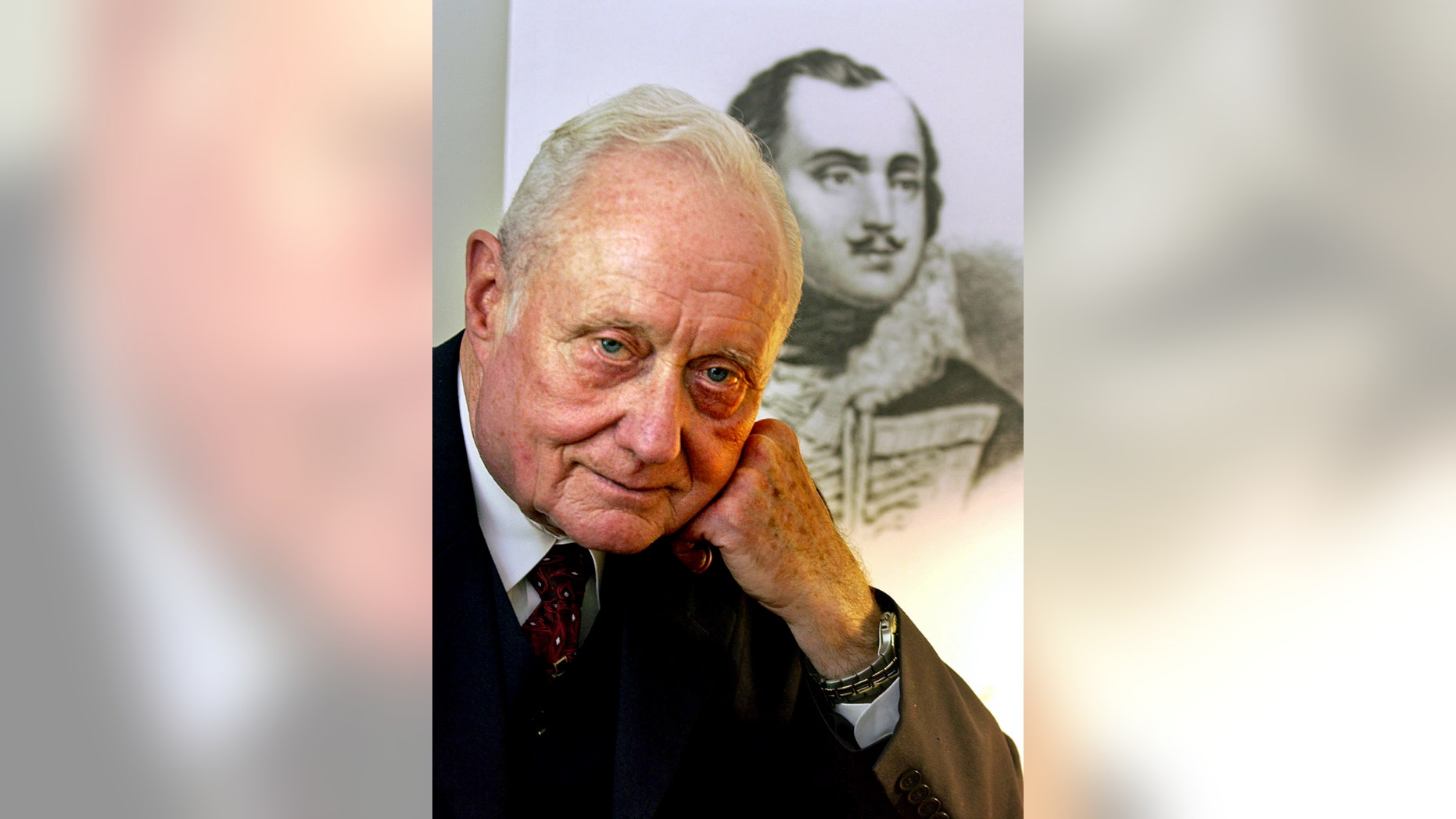 FILE - In this June 23, 2005 file photo, Dr. James C. Metts Jr., the Chatham County coroner, poses in front of a portrait of Brig. Gen. Casimir Pulaski in Savannah, Ga. For 40 years Dr. James C. Metts Jr. served unchallenged as the Savannah area’s county coroner, a job in which he once exhumed the body of a Revolutionary War hero and landed a bit part in the best-selling book “Midnight in the Garden of Good and Evil.” He coasted to re-election last fall at age 81, then a month later abruptly resigned. Now the Georgia Bureau of Investigation says it’s looking into allegations Metts misused taxpayer funds. (AP Photo/Stephen Morton, File)