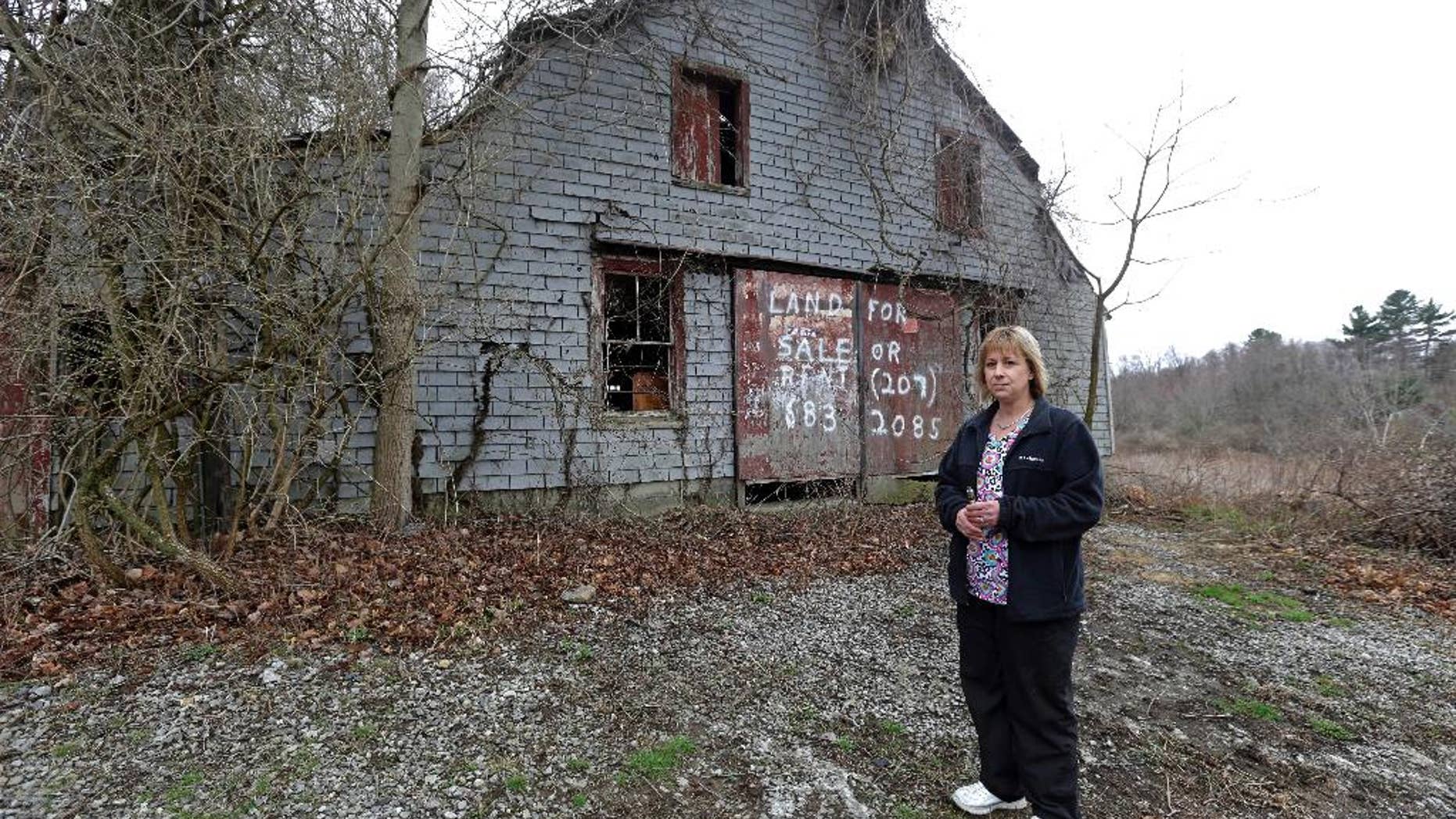 File -- In this April 12, 2016 file photo Desiree Moninski, stands on land located across from her house in Dudley, Mass., which is the site of a proposed Muslim cemetery. Federal prosecutors have opened an investigation into whether civil rights laws were violated by the town of Dudley that has rejected plans for the Muslim cemetery. (AP Photo/Elise Amendola, File)