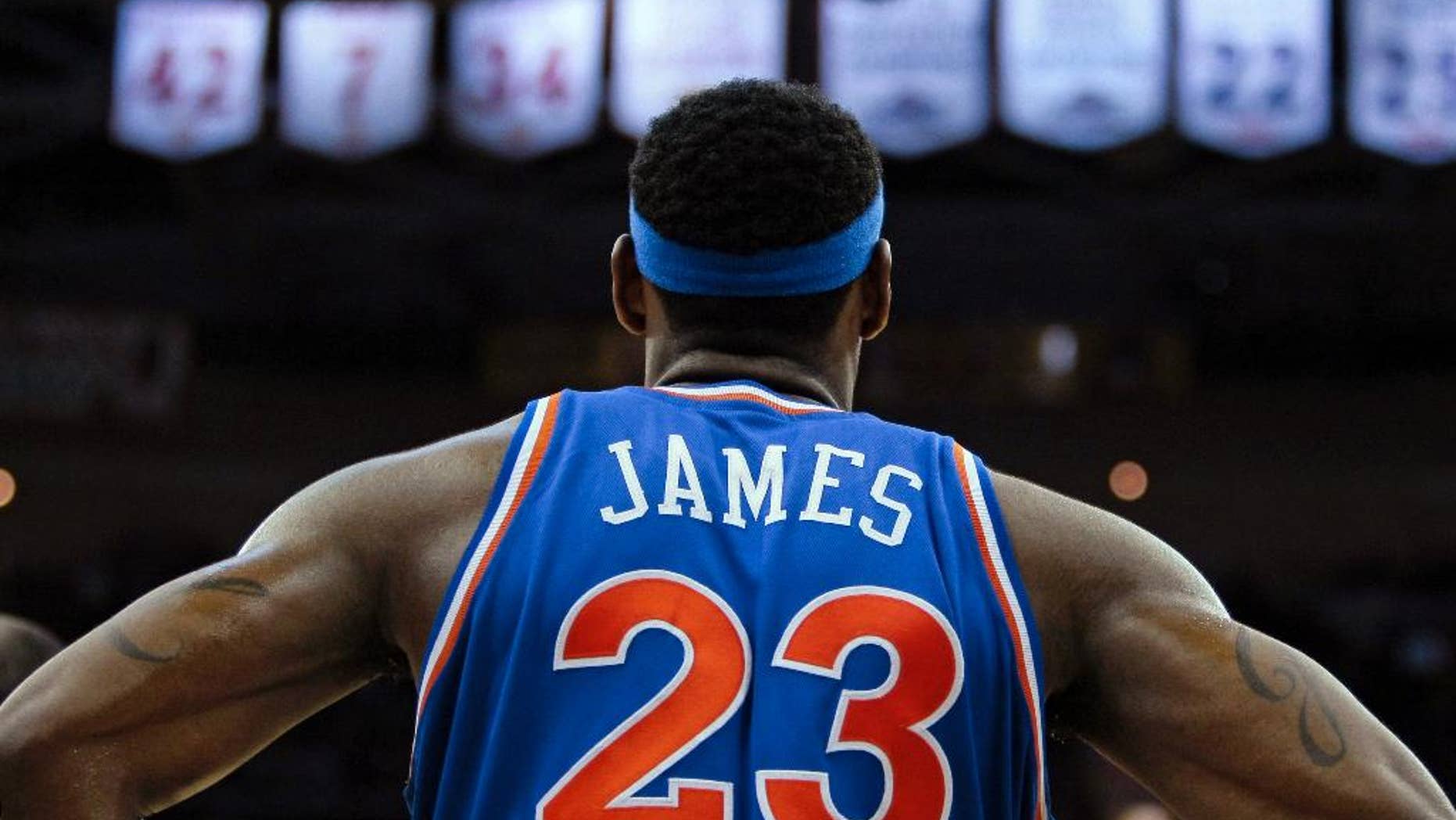 FILE - In this Feb. 23, 2010, file photo, Cleveland Cavaliers forward LeBron James waits for play to resume in an NBA basketball game against the New Orleans Hornets in Cleveland. Four years after he left for Miami, a widely criticized departure that damaged his image and crushed a long-suffering city's championship hopes, James is coming back to play for the Cavaliers to try and end Cleveland's half-century title drought. (AP Photo/Tony Dejak, File)
