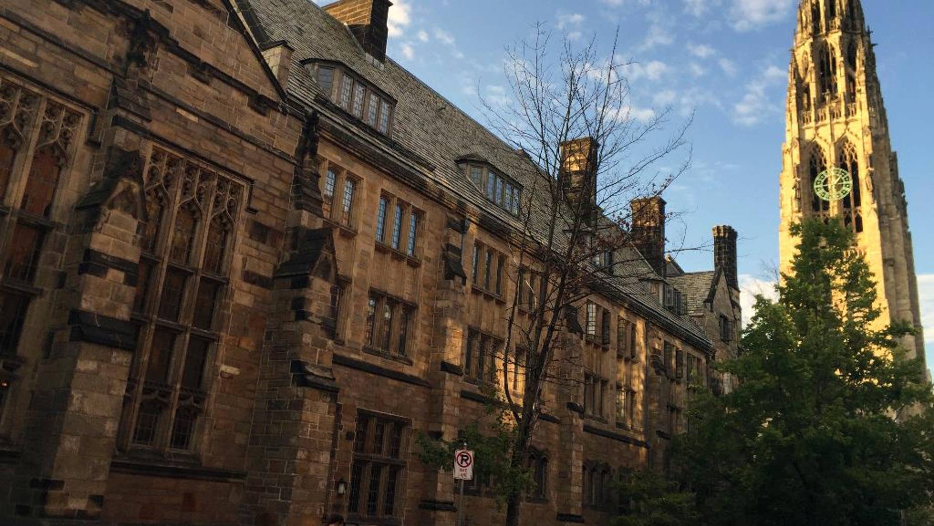 FILE - This Sept. 9, 2016 photo shows Harkness Tower on the campus of Yale University in New Haven, Conn. Harvard University is taking new steps to confront its past ties to slavery. The Ivy League school is hosting a conference Friday, March 3, 2017, exploring the historical ties between slavery and early universities, including Harvard. (AP Photo/Beth J. Harpaz, File)