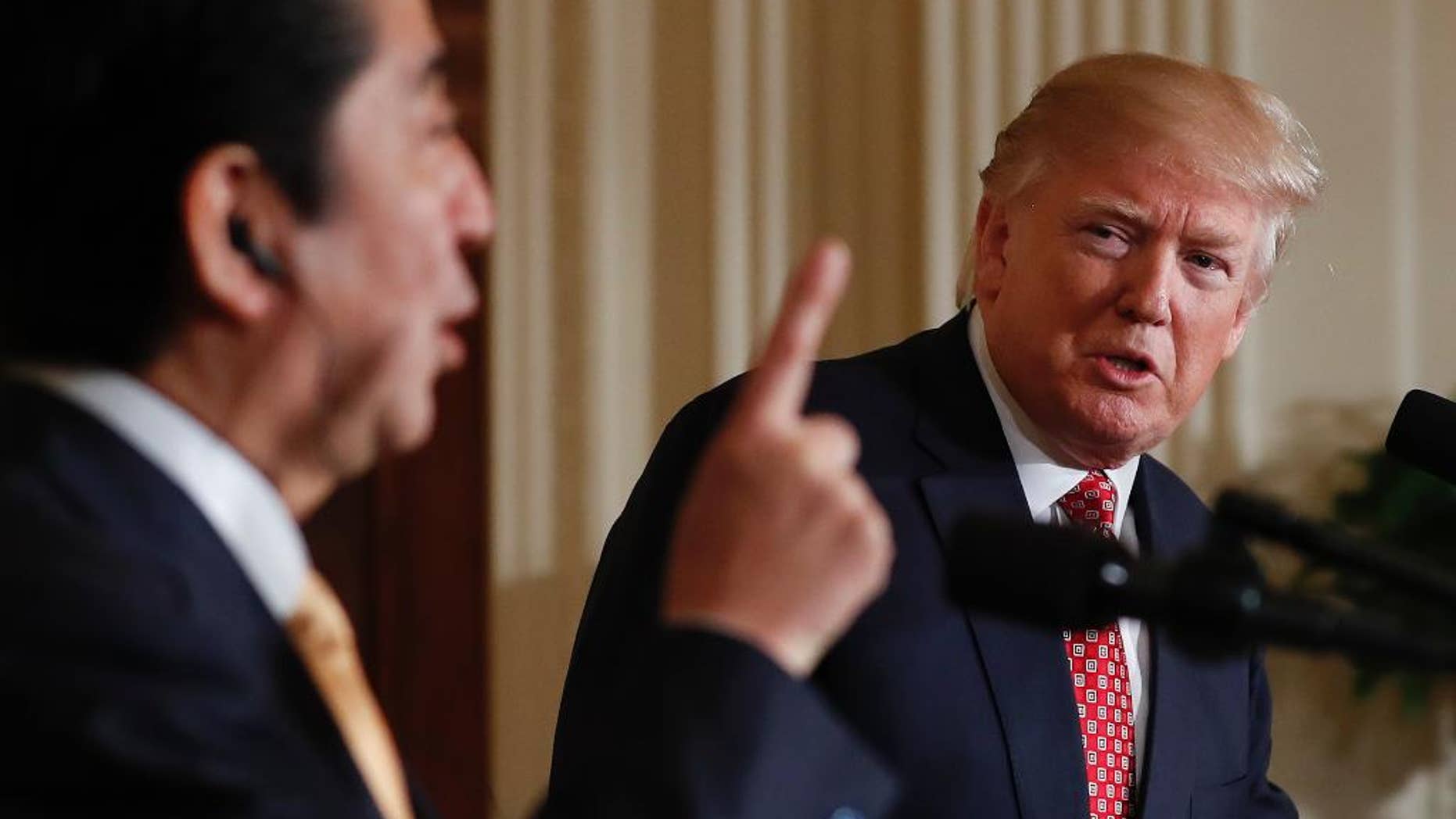 President Donald Trump listens Japanese Prime Minister Shinzo Abe speaks during a joint new conference in the East Room of the White House, in Washington, Friday, Feb. 10, 2017. (AP Photo/Carolyn Kaster)