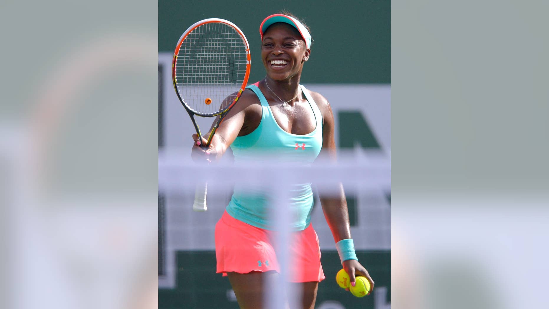 Sloane Stephens smiles prior to serving to Flavia Pennetta, of Italy, during a quarterfinal match at the BNP Paribas Open tennis tournament, Thursday, March 13, 2014, in Indian Wells, Calif. (AP Photo/Mark J. Terrill)