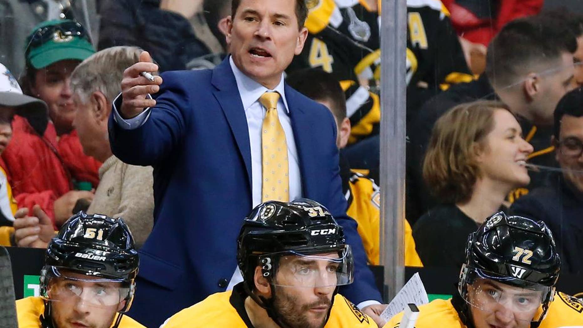 FILE - In this April 8, 2017, file photo, Boston Bruins interim head coach Bruce Cassidy works behind the bench in the third period of an NHL hockey game against the Washington Capitals. The Bruins said on Wednesday, April 26, 2017, it will drop the interim tag and Cassidy will return next season as the team's head coach. Cassidy replaced Claude Julien in February and helped the team return to the playoffs for the first time in three seasons. (AP Photo/Winslow Townson, File)