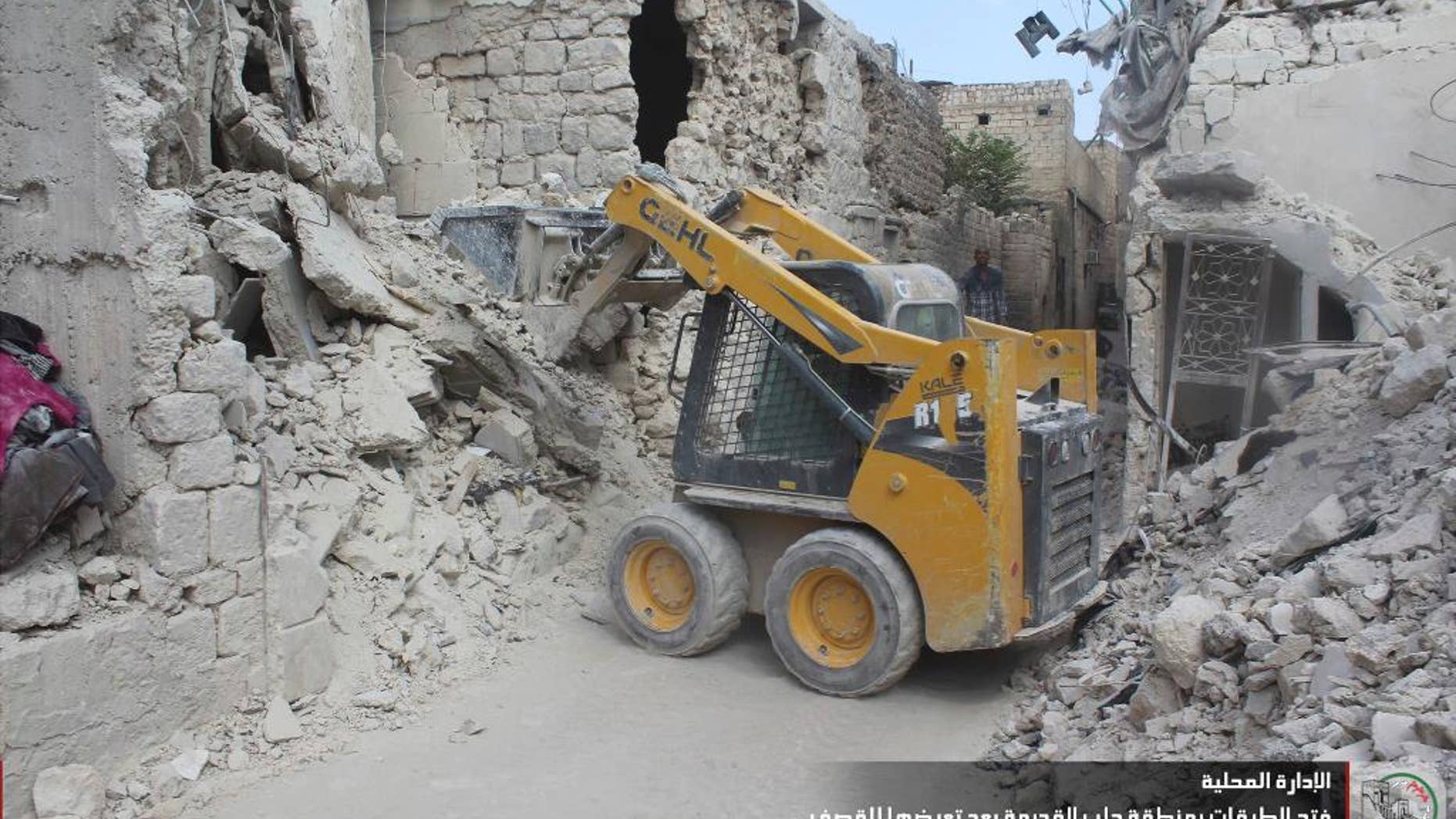 In this photo taken Sept. 26, 2016 and provided by the local council of Aleppo city, Syrians workers clean damaged after airstrikes, in Aleppo, Syria. The opposition-held districts of the Syrian city have been surrounded and under siege for months. Russian and Syrian warplanes are bombing the streets into rubble and government forces are chipping away at the pocket of opposition control. (Local Council of Aleppo City via AP)