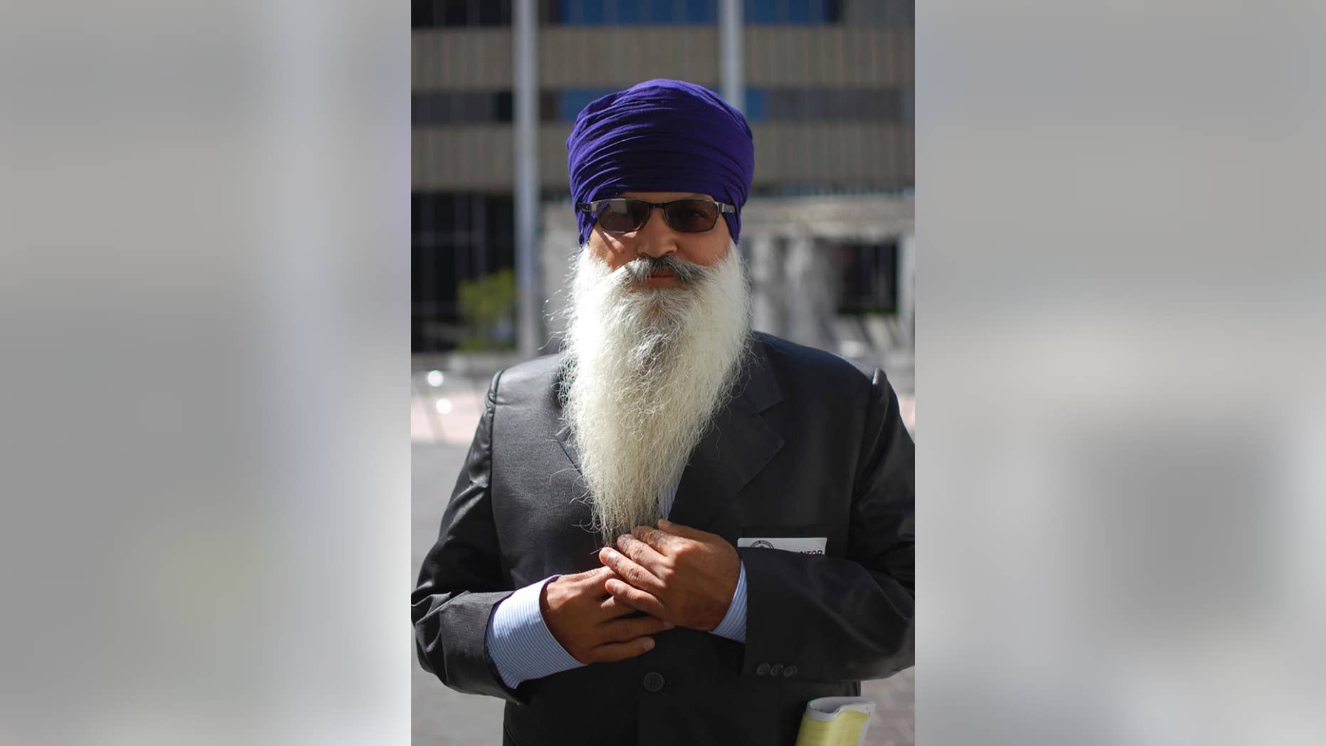 This May 12, 2015, photo provided by the Sikh Coalition shows Lakhbir Singh, one of the four truckers in the case against J.B. Hunt Transportation Services Inc., taken at the Los Angeles Equal Employment Opportunity Commission office during conciliation in Los Angeles. Four Sikh truckers who could not comply with drug testing that required them to provide clipped hair samples or remove their turban because those violate religious principles reach a settlement with a major national trucking company. (Simran Kaur/The Sikh Coalition via AP)