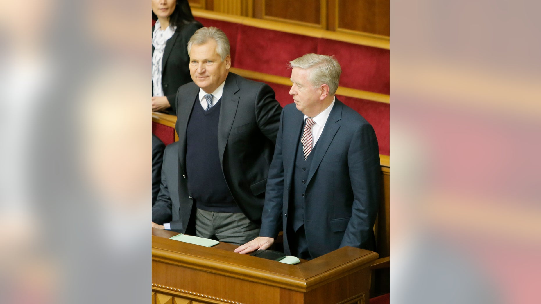 Former President of the European Parliament Patrick Cox, right, and former Polish President Aleksander Kwasniewski, watch a parliament session in Kiev, Ukraine, Wednesday, Nov. 13, 2013. A vote on various bills that would allow the release of Ukraine's jailed former premier Yulia Tymoshenko is scheduled for Wednesday. (AP Photo/Efrem Lukatsky)