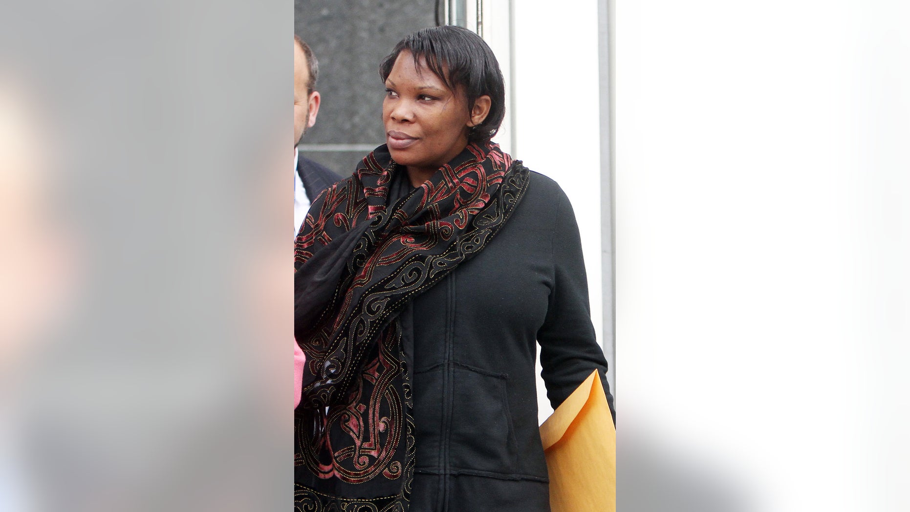 In this April 12, 2012 file photo, Beatrice Munyenyezi leaves the federal courthouse in Concord, N.H., after a mistrial in a case on whether she lied about her role in the 1994 Rwanda genocide to obtain U.S. citizenship. On Thursday Feb. 21, 2013 a jury convicted Munyenyezi of lying about Rwanda genocide to get U.S. citizenship. U.S. District Judge Steven McAuliffe stripped her of her citizenship and ordered her detained until her sentencing, scheduled for June 3. Her lawyers said they will appeal. (AP Photo/Jim Cole)