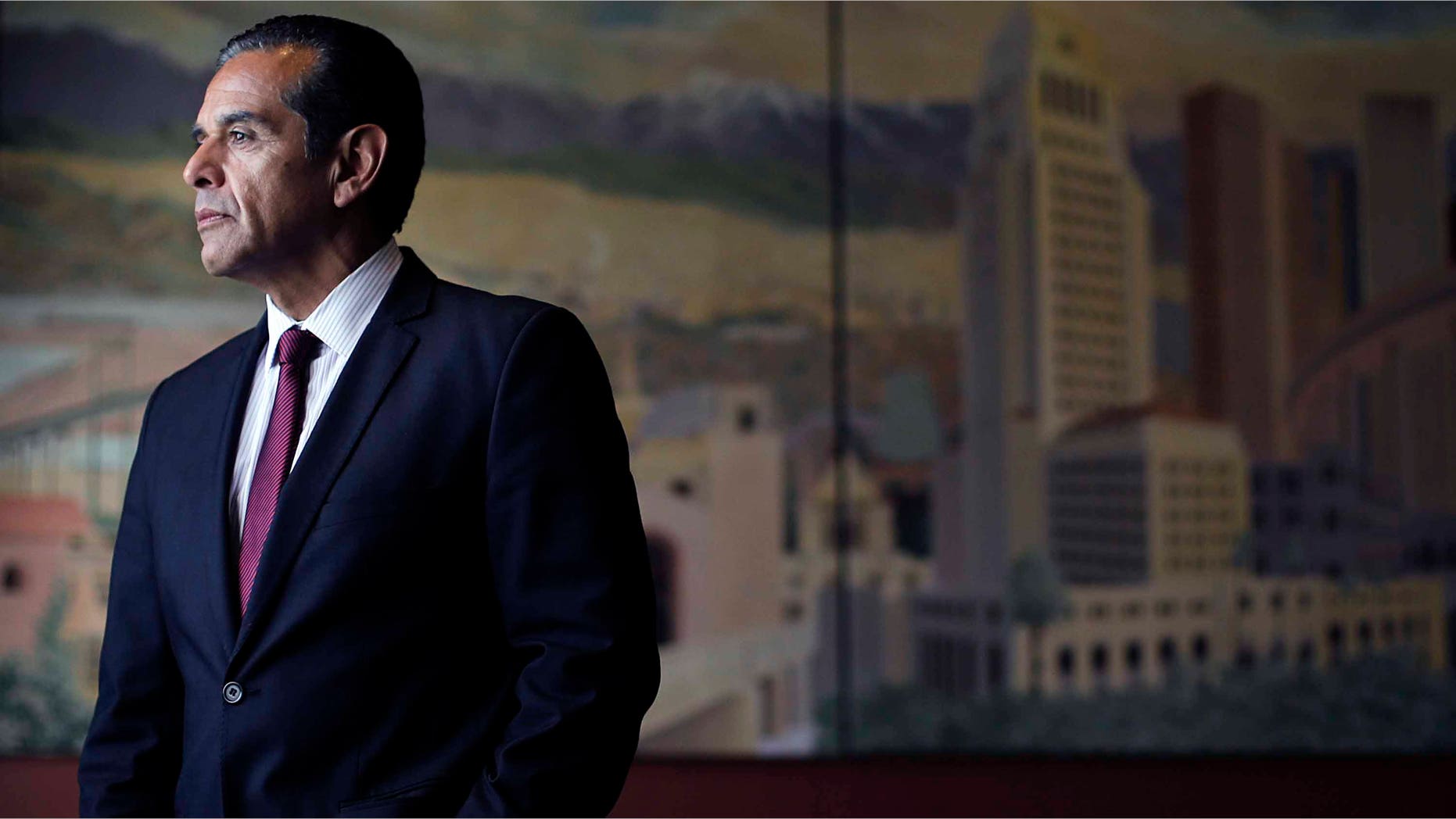 FILE-This June 19, 2013 file photo Los Angeles Mayor Antonio Villaraigosa pauses for photos in his office in Los Angeles. Villaraigosa says he won't run for Barbara Boxer's U.S. Senate seat. The announcement quashes a highly anticipated showdown with state Attorney General Kamala Harris. (AP Photo/Jae C. Hong,File)
