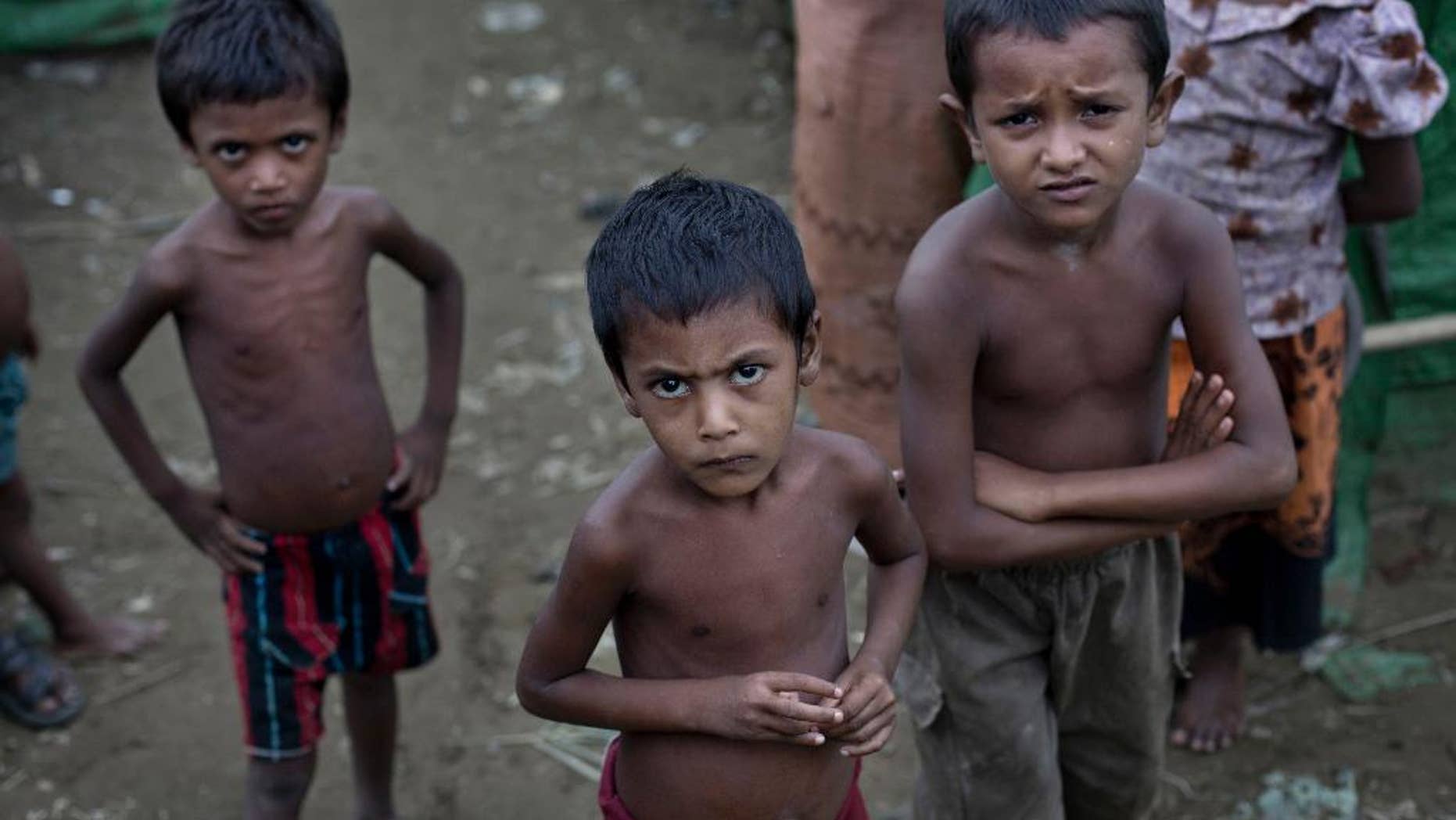 FILE - In this June 24 2014, file photo, Rohingya children gather at the Dar Paing camp for Muslim refugees, north of Sittwe, western Rakhine state, Myanmar. Activists this week have sent an open letter asking the major corporate investor conglomerate Unilever, which owns two factories near the capital Yangon, to speak out against the country's treatment of its Rohingya minority. (AP Photo/ Gemunu Amarasinghe, File)