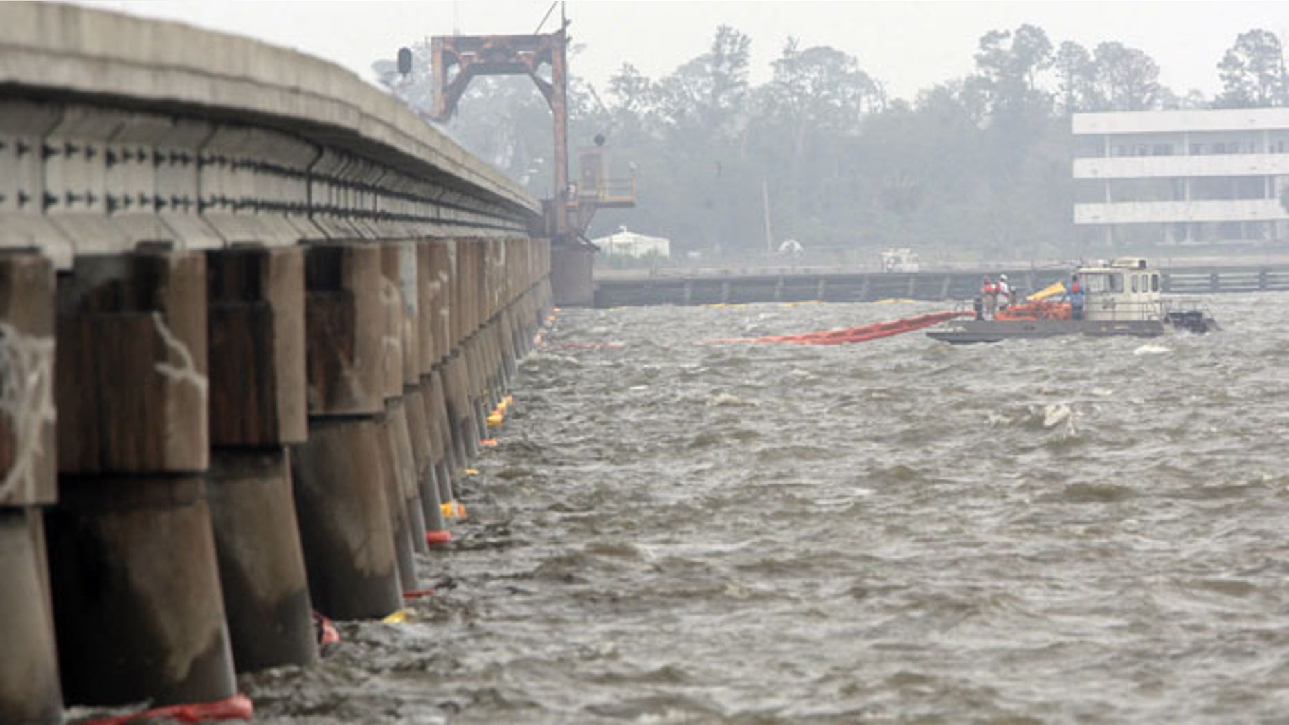 April 30: Workers spread oil booms along a railroad trestle that crosses the bay in Bay St. Louis, Miss., as preparations continue to head off damage from an inpending oil spill along the Gulf coast.