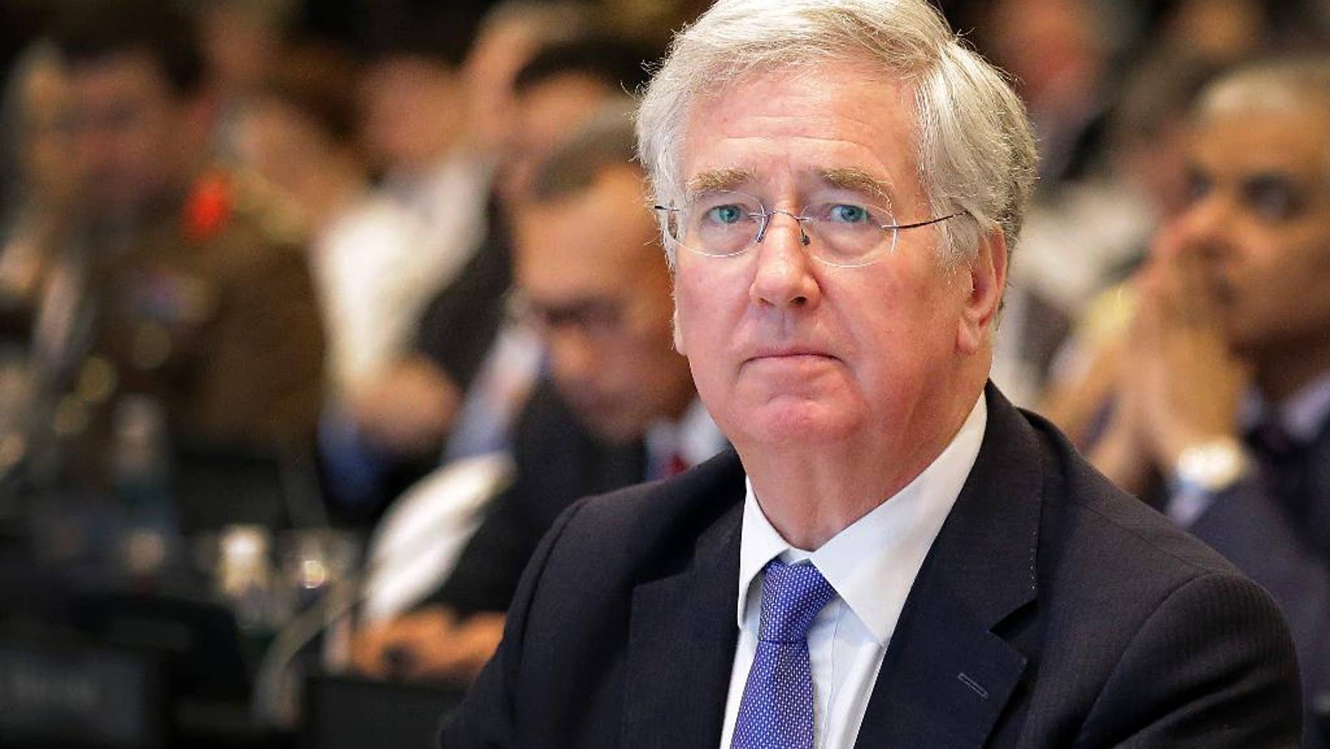FILE - This is a Saturday, June 4, 2016 file photo of British Defense Secretary Michael Fallon as he attends the 15th International Institute for Strategic Studies Shangri-la Dialogue, or IISS, Asia Security Summit in Singapore. Michael Fallon said Monday July 18, 2016 that Britain will have to work harder to maintain its military and political influence on the global stage after it leaves the European Union. (AP Photo/Wong Maye-E, File)