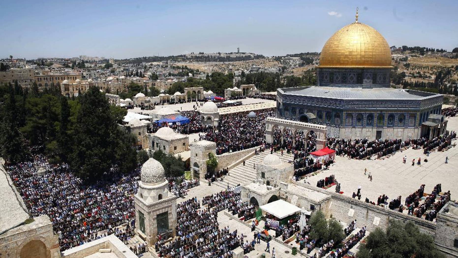 FILE - In this June 17, 2016 file photo, Palestinians pray in the Al Aqsa Mosque compound during the Muslim holy month of Ramadan, in Jerusalem's Old City. The Palestinians are ringing alarm bells over Donald Trump's stated intention to relocate the U.S. Embassy in Israel to contested Jerusalem, fearing quick action once he takes office as U.S. president next week. They say an embassy move would kill any hopes for negotiating an Israeli-Palestinian border deal and rile the region by undercutting Muslim and Christian claims to the holy city. (AP Photo/Mahmoud Illean, File)