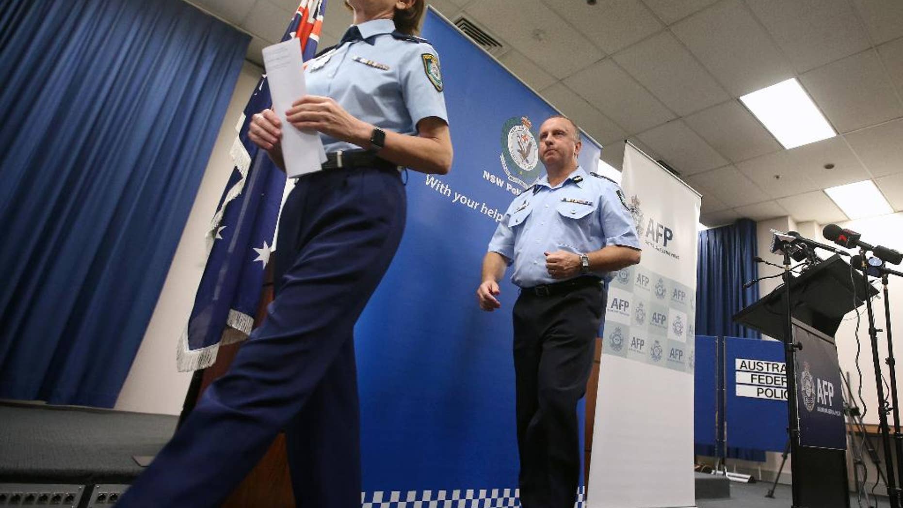 FILE - In this May 17, 2016 file photo, New South Wales Deputy Police Commissioner Catherine Burn, left, and Australian Federal Police Acting Deputy Commissioner Neil Gaughan leave a news conference in Sydney. A man charged with committing a terrorist act and attempted murder after allegedly stabbing a man in Sydney was inspired by the Islamic State group, police said Sunday, Sept. 11. The suspect, Ihsas Khan, 22, and Wayne Greenhalgh, 59, who was stabbed several times by Khan, did not know each other, and Burn described the attack as planned and deliberate. "This was clearly a very volatile, a very violent situation that police and the members of the community were confronted with," Burn told reporters. (AP Photo/Rick Rycroft, File)