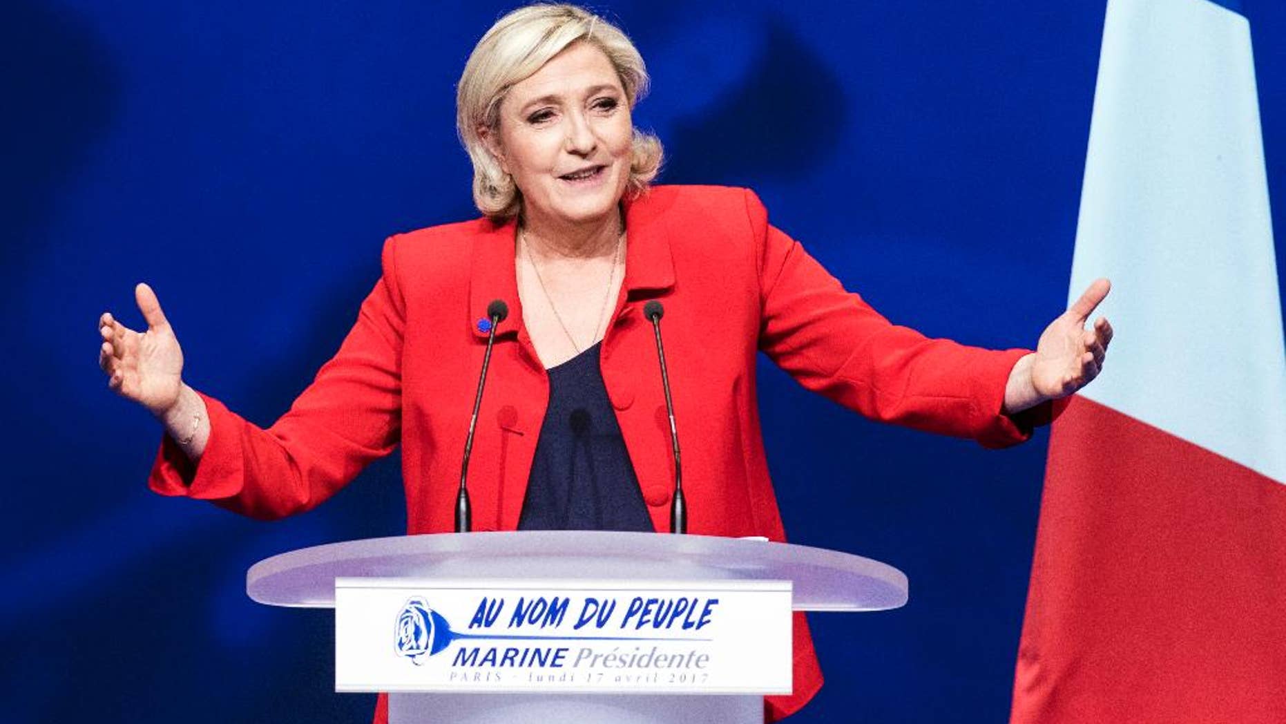 FILE - In this Monday, April 17, 2017 file photo, far-right candidate for the presidential election Marine Le Pen speaks during a campaign meeting in Paris. They could hardly be more different: Pro-European centrist Emmanuel Macron is facing anti-immigration, anti-EU Marine Le Pen in France’s presidential runoff May 7. (AP Photo/Kamil Zihnioglu, file)