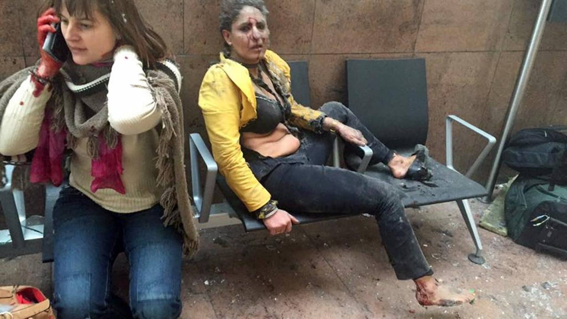 FILE - This Tuesday, March 22, 2016, file photo provided by Georgian Public Broadcaster and photographed by Ketevan Kardava shows Nidhi Chaphekar, right, a 40-year-old Jet Airways flight attendant from Mumbai, and another unidentified woman after being wounded in Brussels Airport in Brussels, Belgium, after explosions were heard. The Indian flight attendant who was injured in the Brussels airport blasts is in stable condition and recovering, her airline Jet Airways said Friday, March 25, 2016. Chaphekar suffered burns and fractured her foot in the explosions on Tuesday. She has been treated at a hospital near Brussels. (Ketevan Kardava/Georgian Public Broadcaster via AP, File)