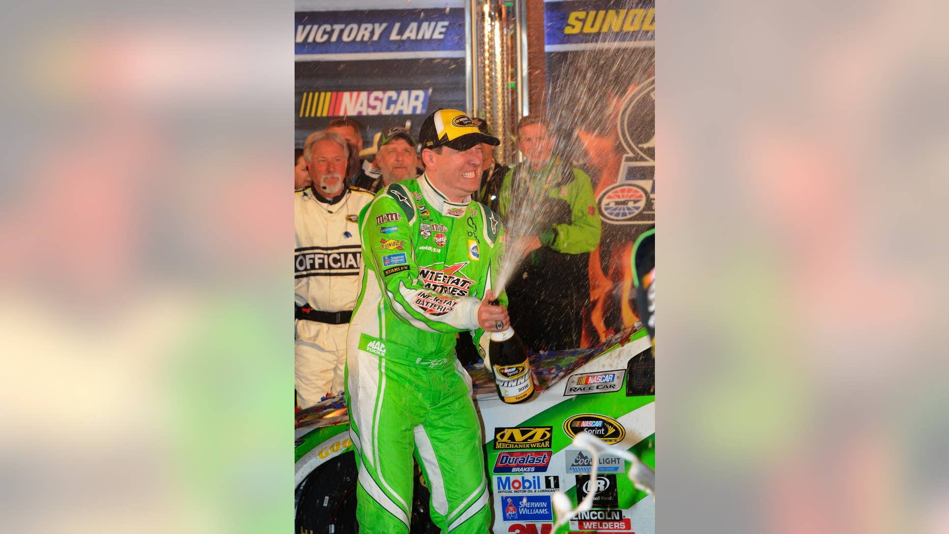 Kyle Busch (18) celebrates winning the NASCAR Sprint Cup Series auto race at Texas Motor Speedway in Fort Worth, Texas, Sunday, April 10, 2016. (AP Photo/Larry Papke)